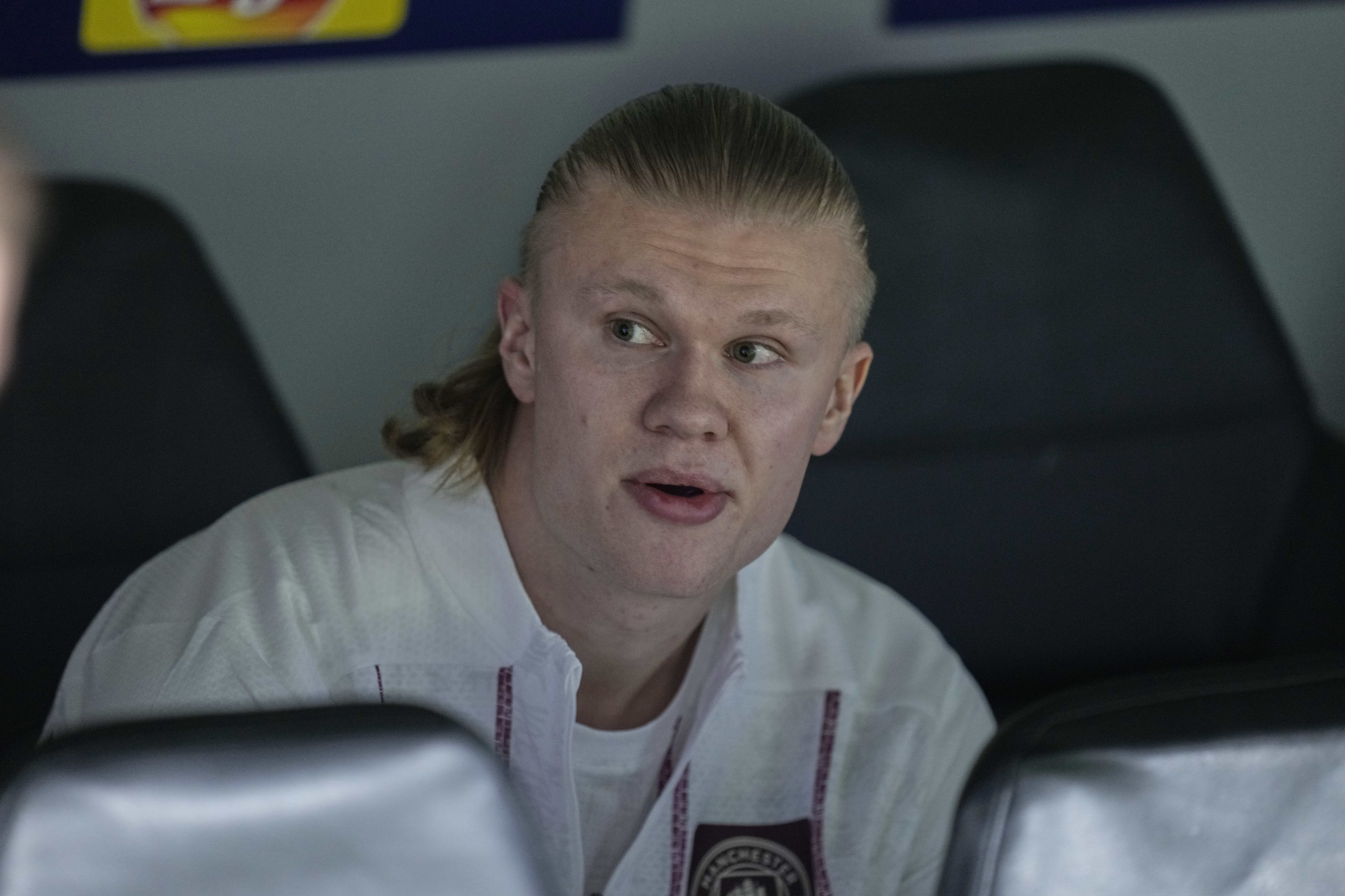 Manchester City's Erling Haaland sits on the bench ahead of the Champions League playoff second leg soccer match between Real Madrid and Manchester City at the Santiago Bernabeu Stadium in Madrid, Spain, Wednesday, Feb. 19, 2025. 