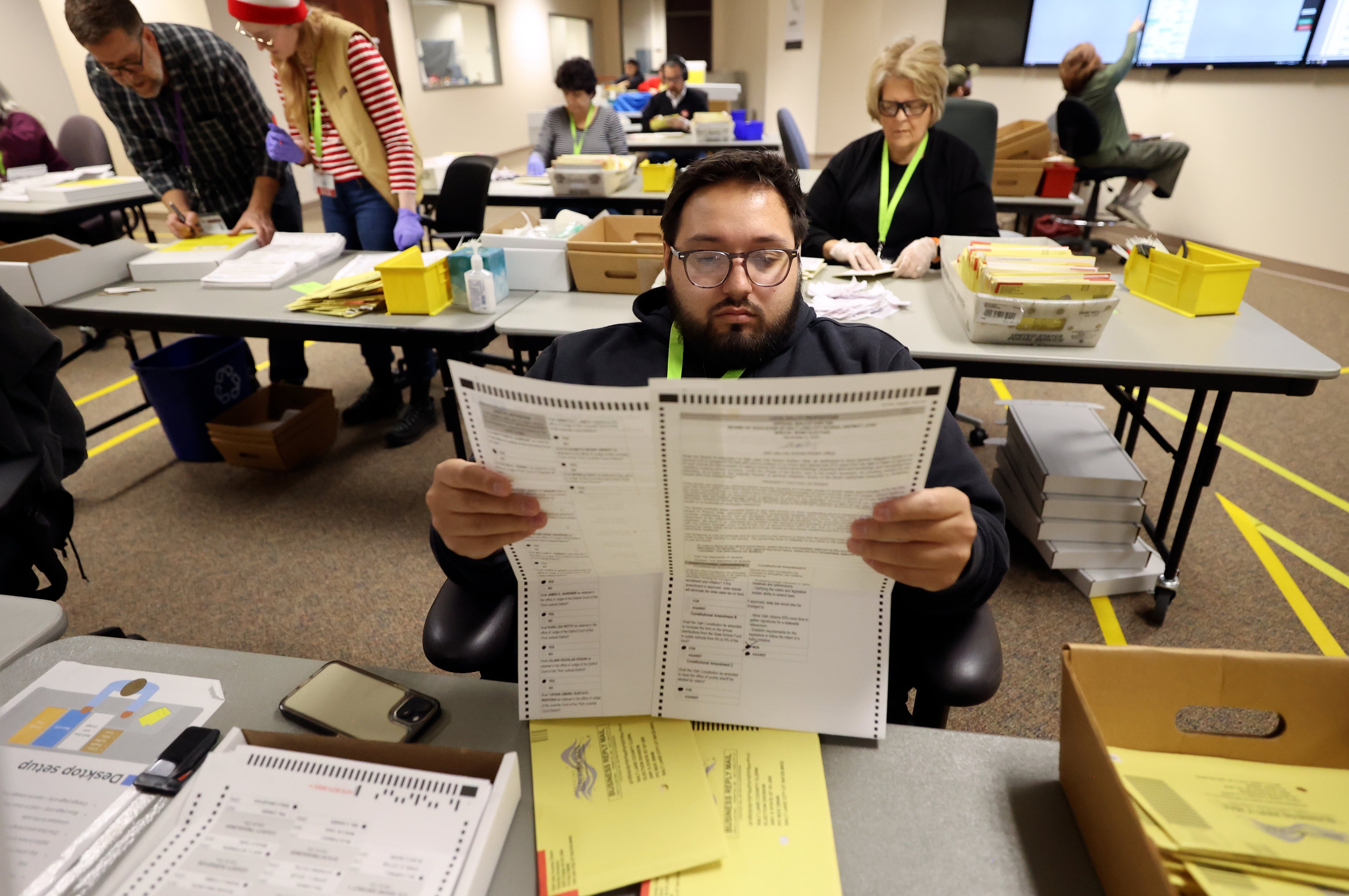 Domonic Montoya processes ballots at the Salt Lake County Government Center on Oct. 31, 2024. Utah lawmakers from the Senate and House spent the last four weeks debating the future of Utah's elections.