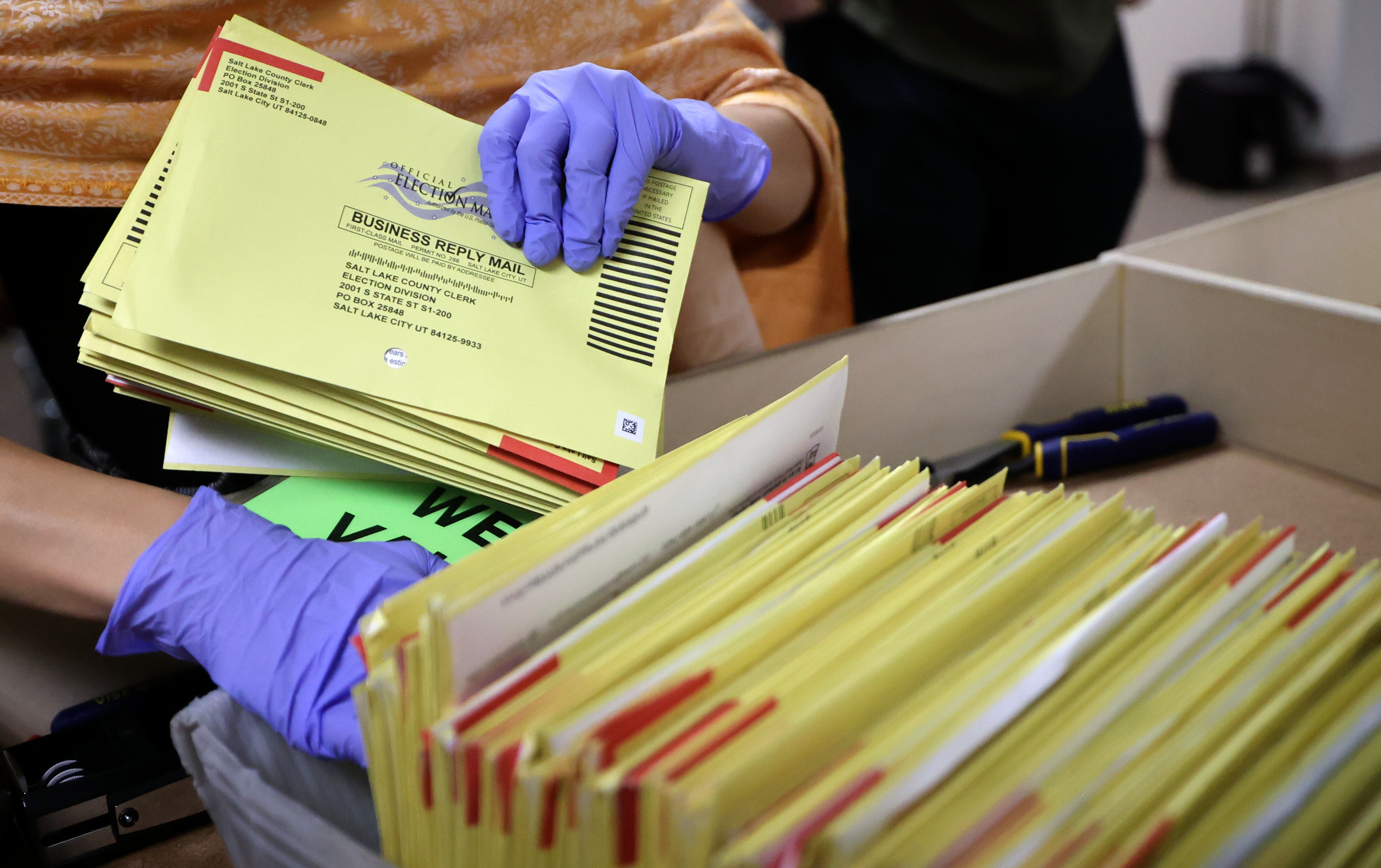 Nikila Venugopal, Salt Lake County Clerk’s Office chief deputy clerk, stacks ballots to process at the Salt Lake County Government Center in Salt Lake City on Oct. 31, 2024.