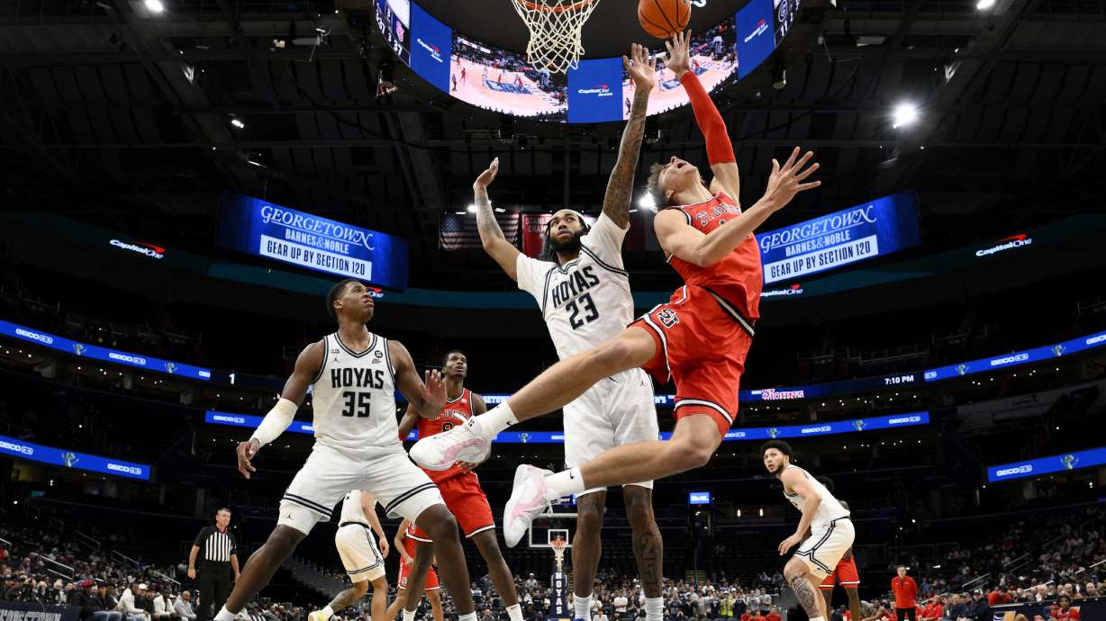 St. John's forward Ruben Prey, right, goes to the basket against Georgetown forwards Jordan Burks (23) and Thomas Sorber (35) during the first half of an NCAA college basketball game, Tuesday, Jan. 28, 2025, in Washington.