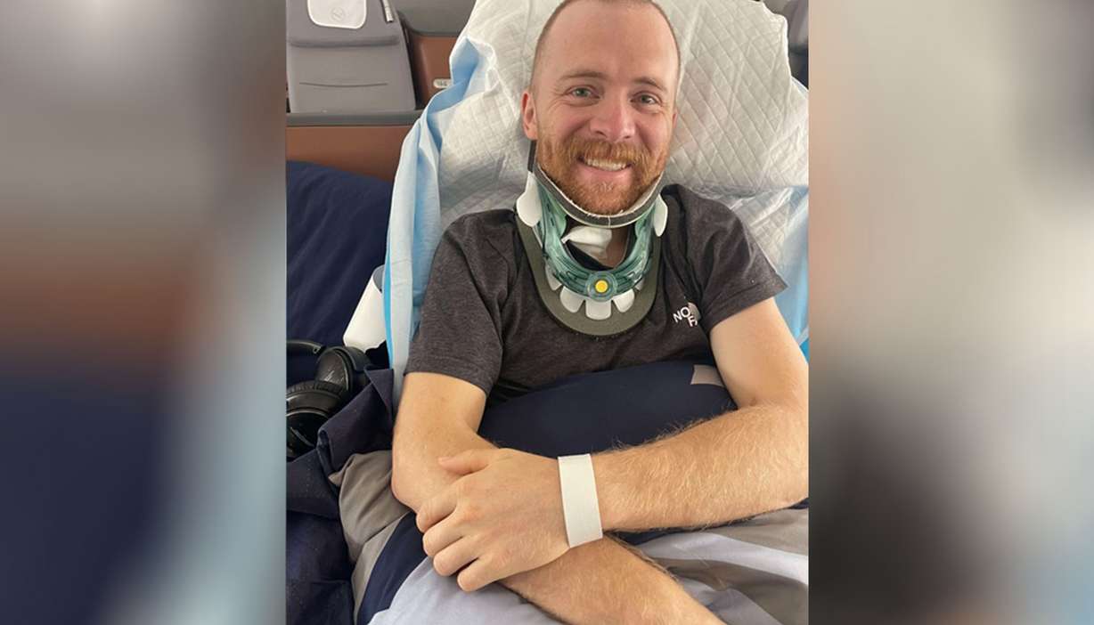 Justin Holman grins on the plane ride to Denver, in an undated photo.