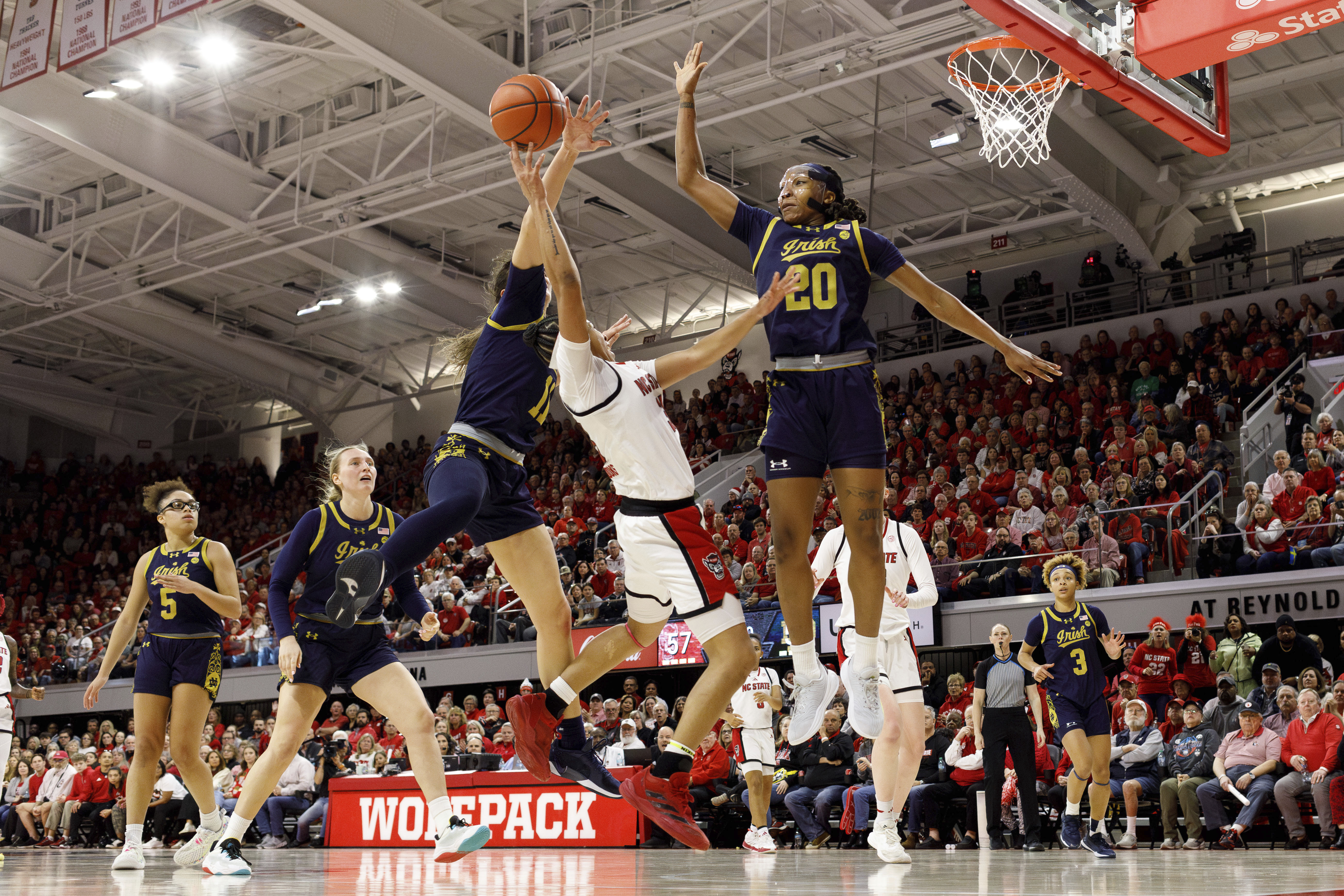 North Carolina State's Zoe Brooks, center, attempts to shoot between Notre Dame's Liatu King (20) and Sonia Citron (11) during the second half of an NCAA college basketball game in Raleigh, N.C., Sunday, Feb. 23, 2025. 