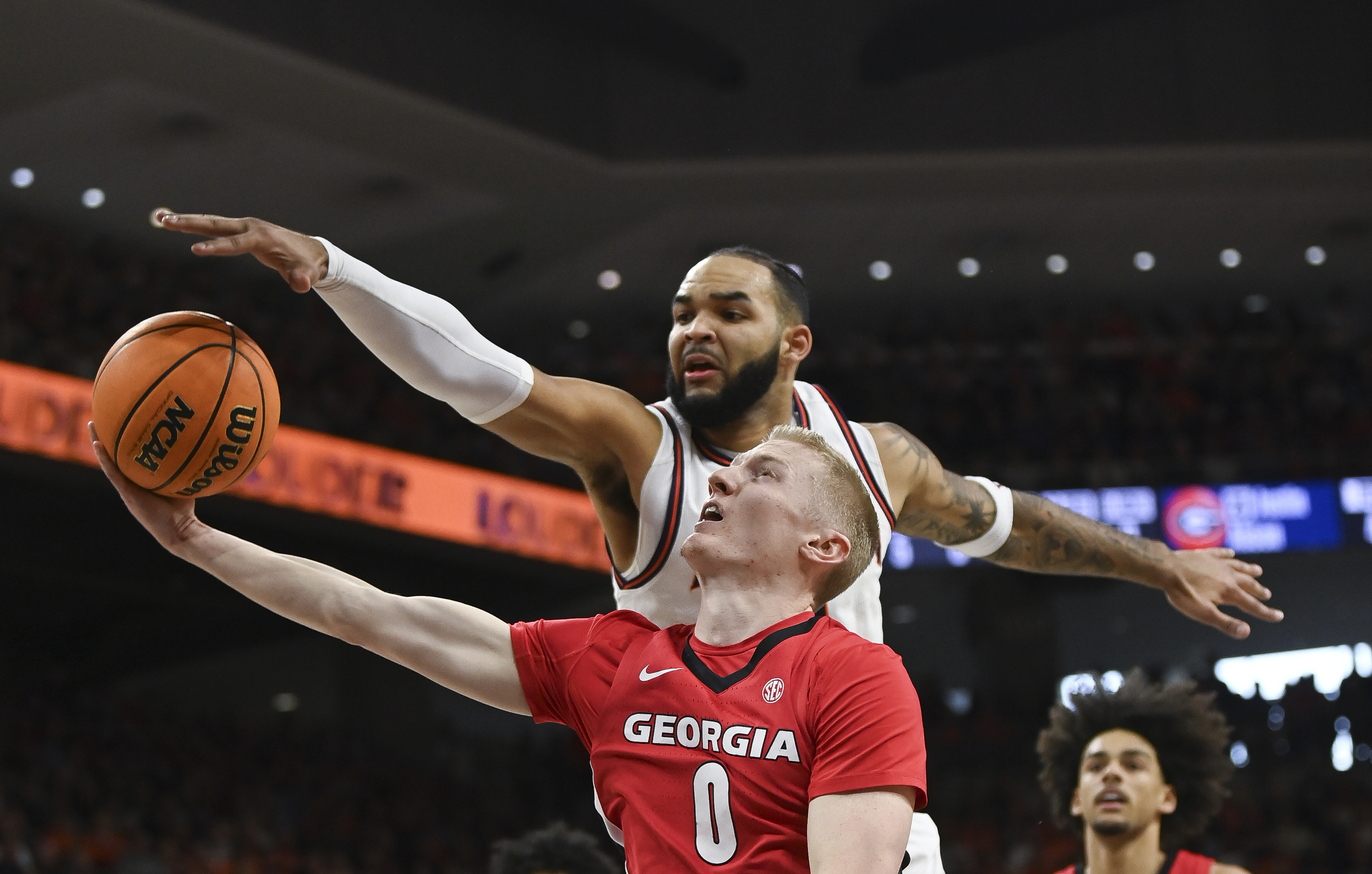 Auburn forward/center Johni Broome (4) blocks a shot by Georgia guard Blue Cain (0) during the first half an NCAA college basketball game Saturday, Feb. 22, 2025, in Auburn, Ala.