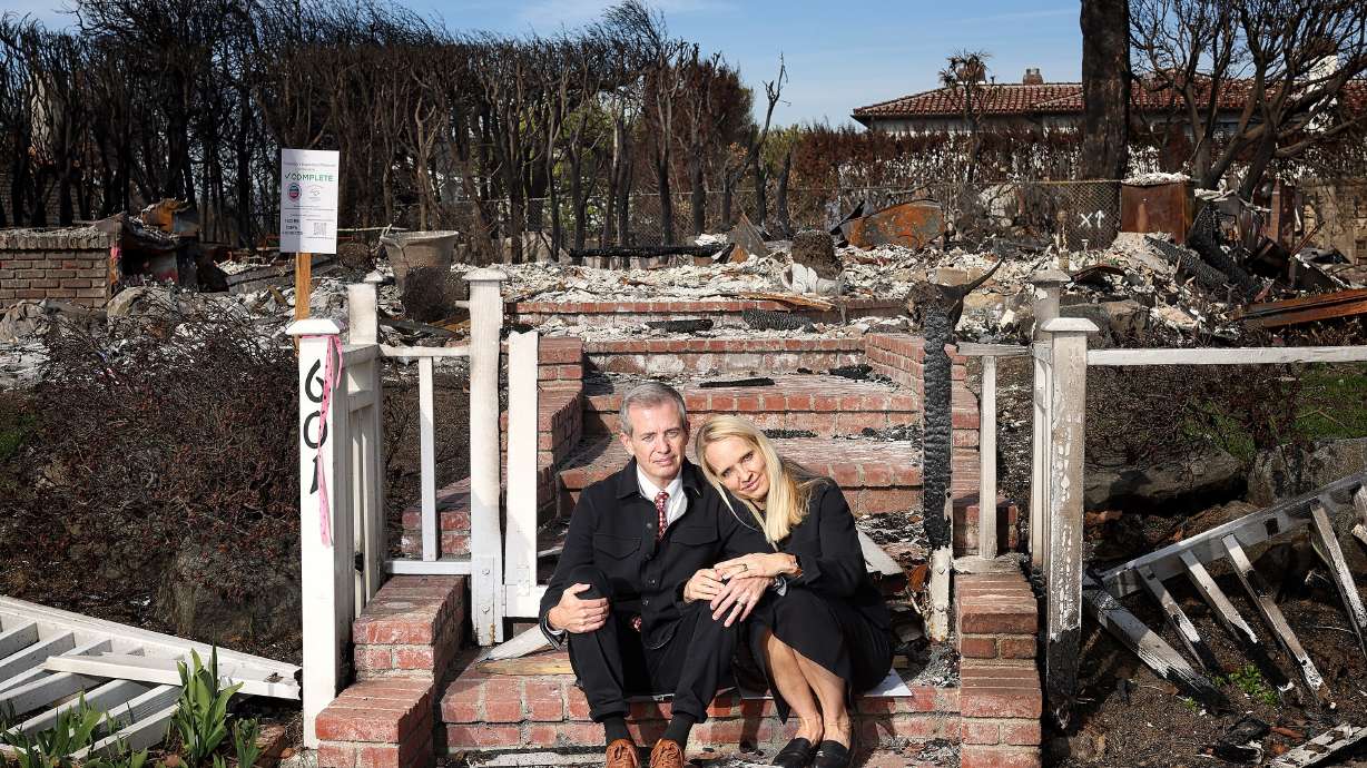 Wendy Garff, 53, and her husband Matthew Garff, 55, sit on the front steps of their destroyed Pacific Palisades, Calif., home that was one of many burned to the ground by the recent wildfires that swept through Southern California. The couple plans on rebuilding and are temporarily living in a rental property in Beverly Hills.