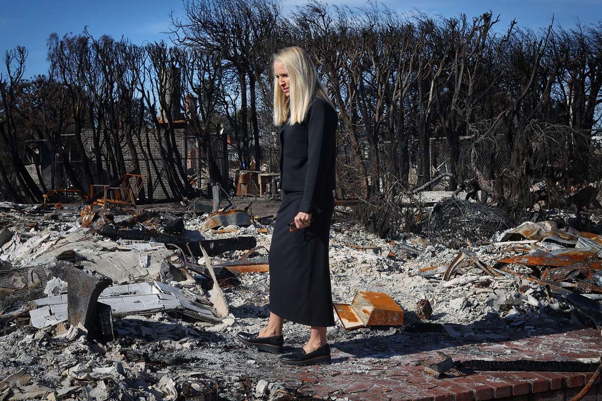 Wendy Garff, 53, walks through the remains of her Pacific Palisades, Calif., home on Feb. 22. Her home was one of many destroyed by the recent wildfires that swept through Southern California. She and her husband Matthew Garff, 55, plan on rebuilding and are temporarily living in a rental property in Beverly Hills.