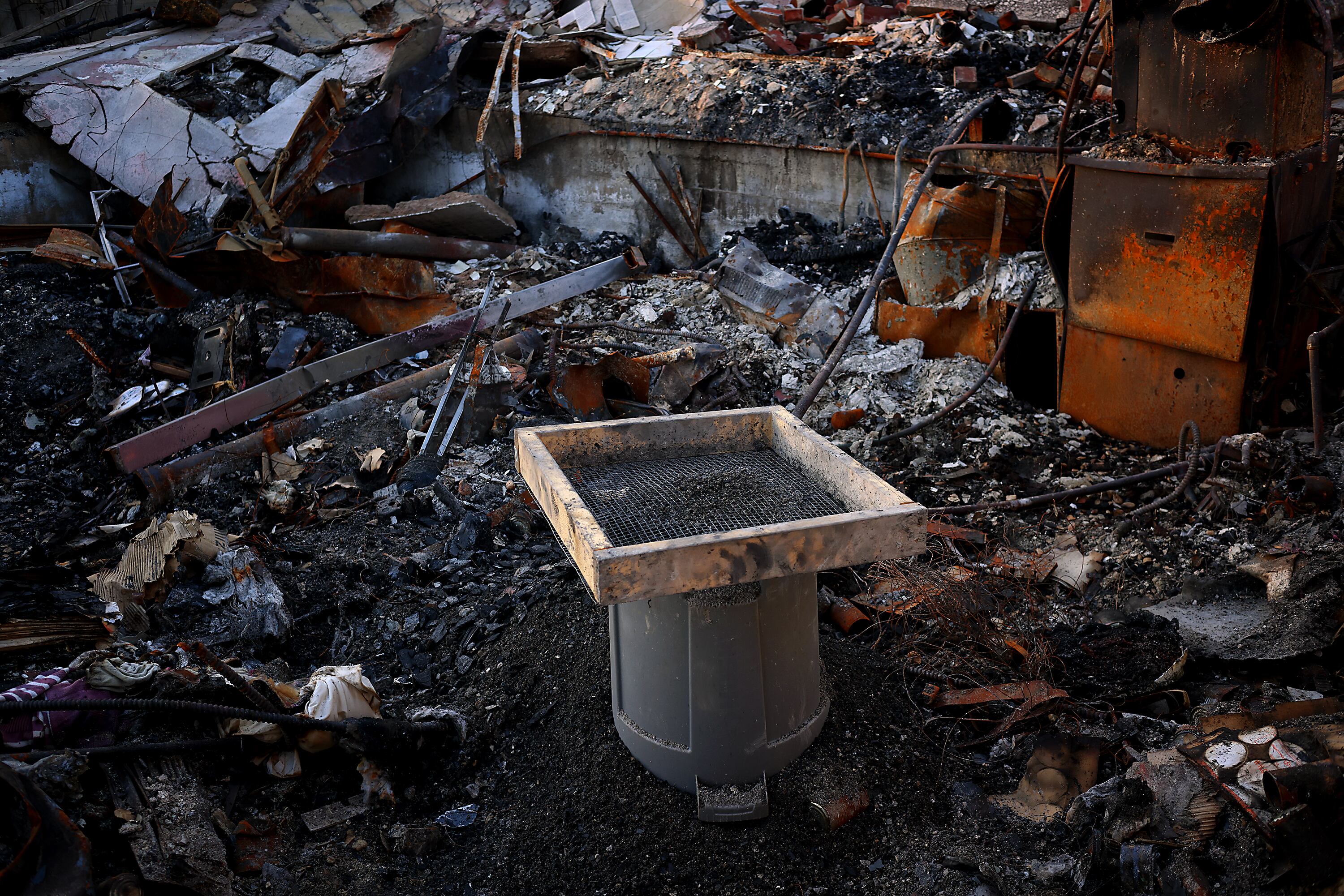 A sifter in the ruins of the Christensens' home