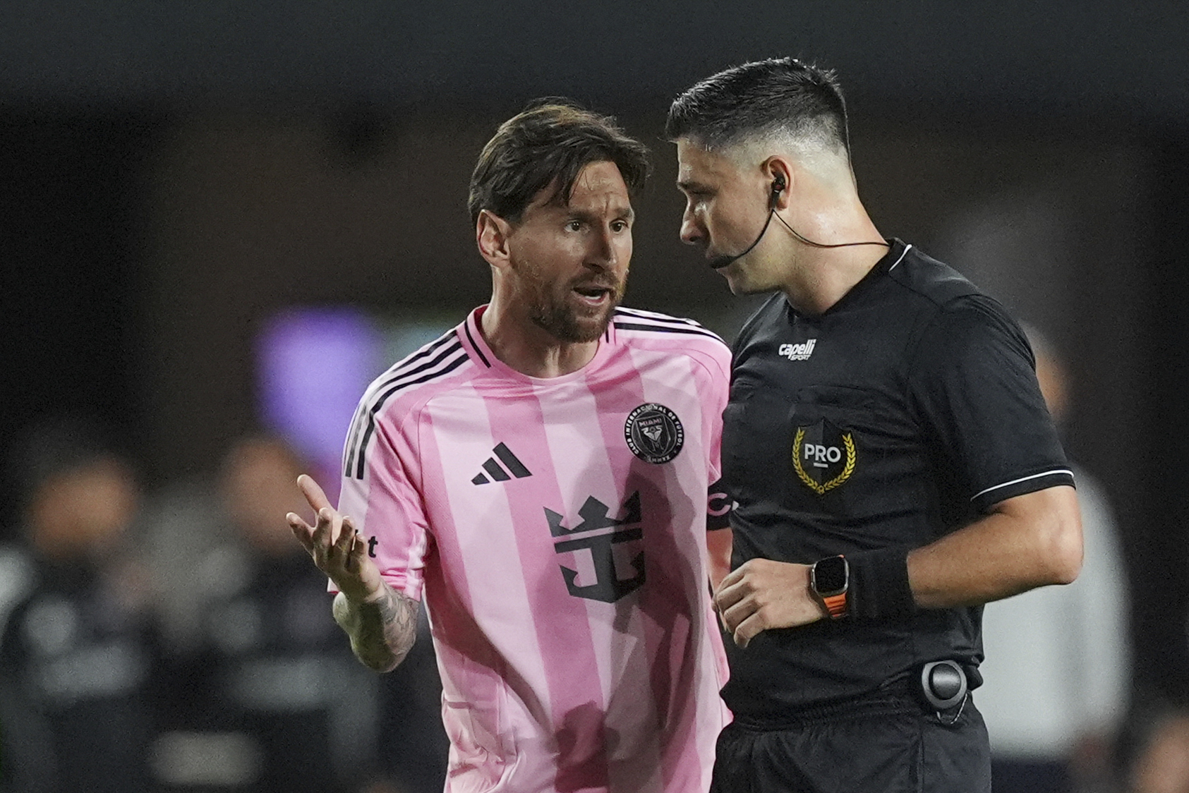 Inter Miami forward Lionel Messi, left, talks with the referee during the first half of an MLS soccer match against New York City FC, Saturday, Feb. 22, 2025, in Fort Lauderdale, Fla. 