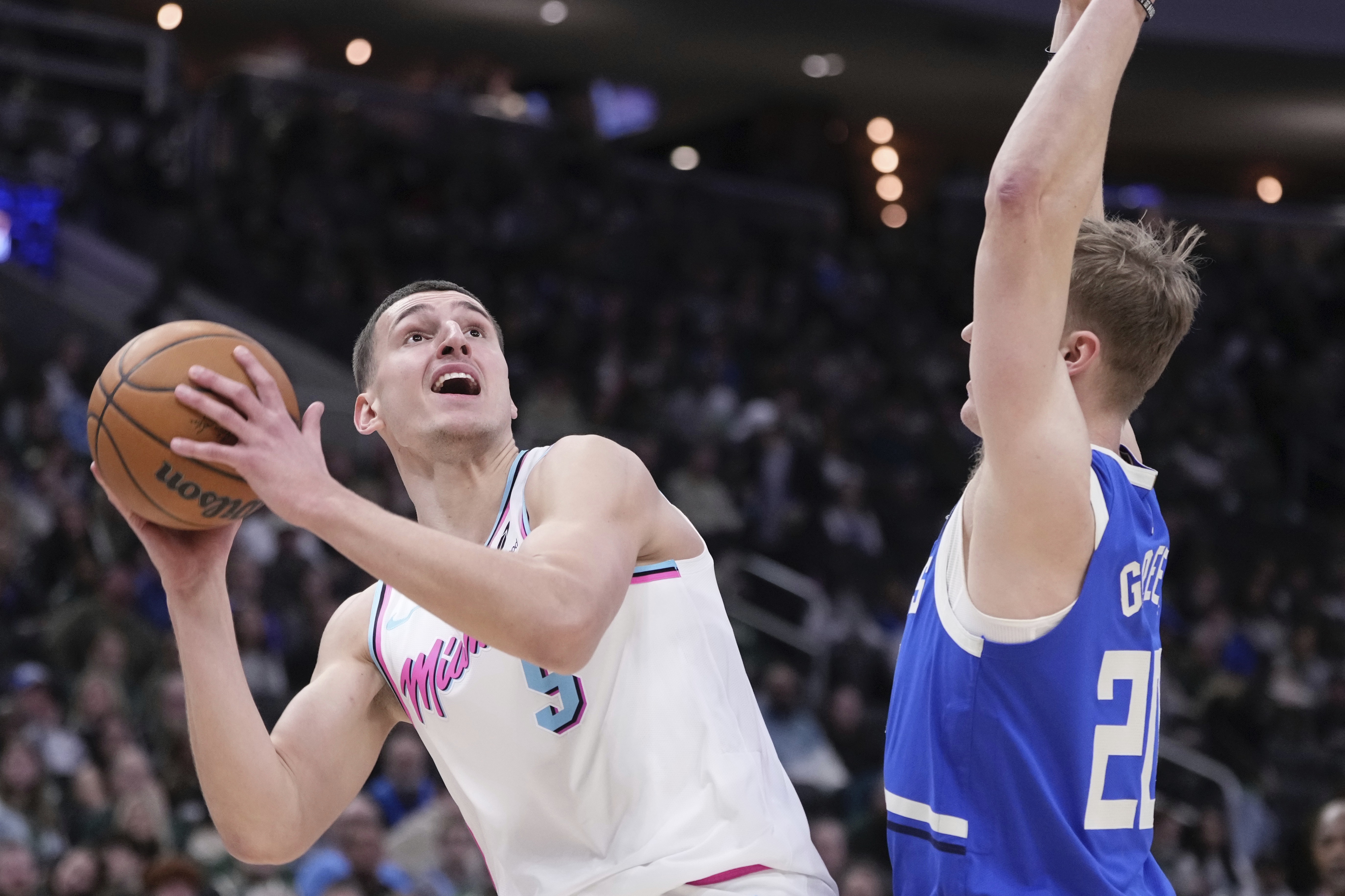 Miami Heat's Nikola Jovic looks to shoot past Milwaukee Bucks' AJ Green during the first half of an NBA basketball game Sunday, Feb. 23, 2025, in Milwaukee. 