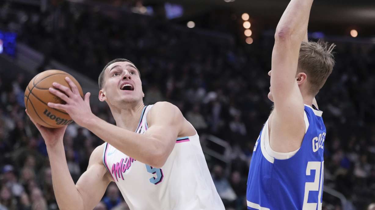 Miami Heat's Nikola Jovic looks to shoot past Milwaukee Bucks' AJ Green during the first half of an NBA basketball game Sunday, Feb. 23, 2025, in Milwaukee.