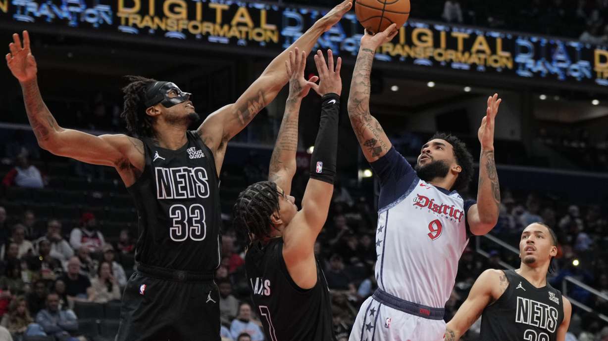 Washington Wizards forward Justin Champagne (9) goes up to shoot against Brooklyn Nets center Nic Claxton (33), guard Killian Hayes (7), and forward Jalen Wilson (22) during the first half of an NBA basketball game Monday, Feb. 24, 2025, in Washington.