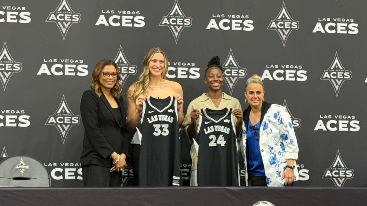 Las Vegas Aces' Liz Kitley, center left, and Jewell Loyd, center right, pose for a photo alongside President Nikki Fargas, left, and Becky Hammon at a presser in Las Vegas, Tuesday, Feb. 25, 2025.