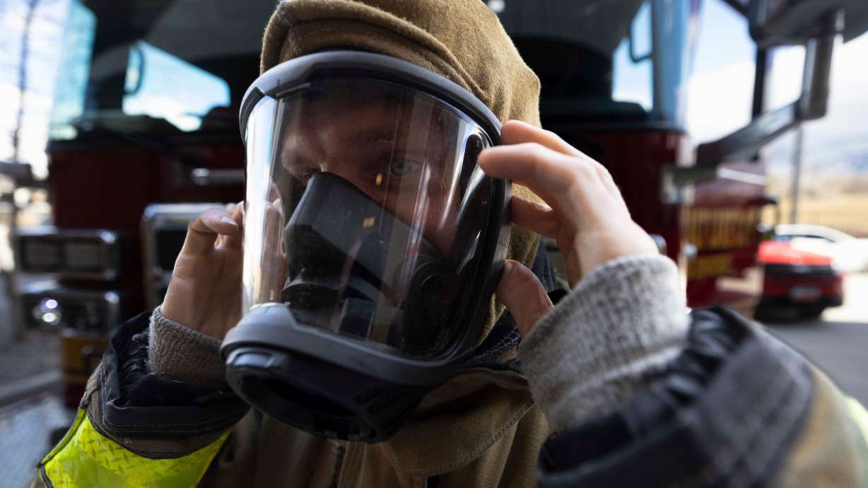 Salt Lake City firefighter Andrew Supko tests his turnout gear, at Salt Lake City Fire Station 3 in Salt Lake City on Tuesday. A bill to set up cancer screenings for firefighters passed through a Senate committee Tuesday after passing the House last week.