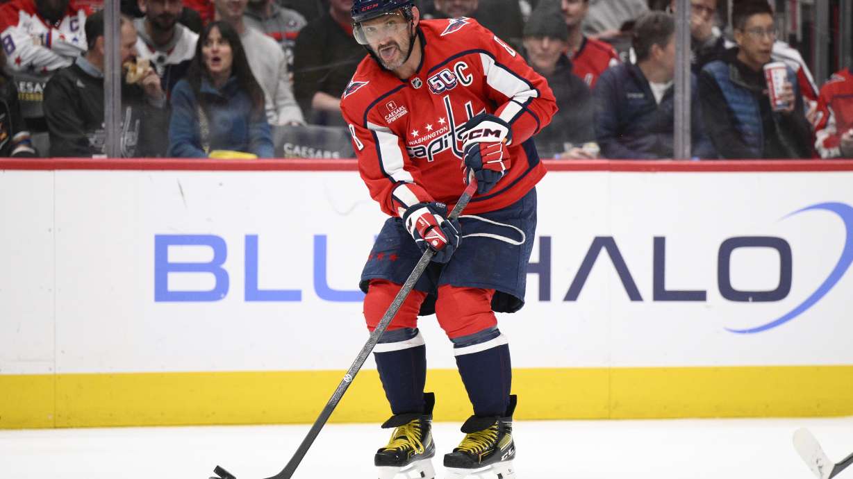 Washington Capitals left wing Alex Ovechkin passes the puck during the second period of an NHL hockey game against the Calgary Flames, Tuesday, Feb. 25, 2025, in Washington.