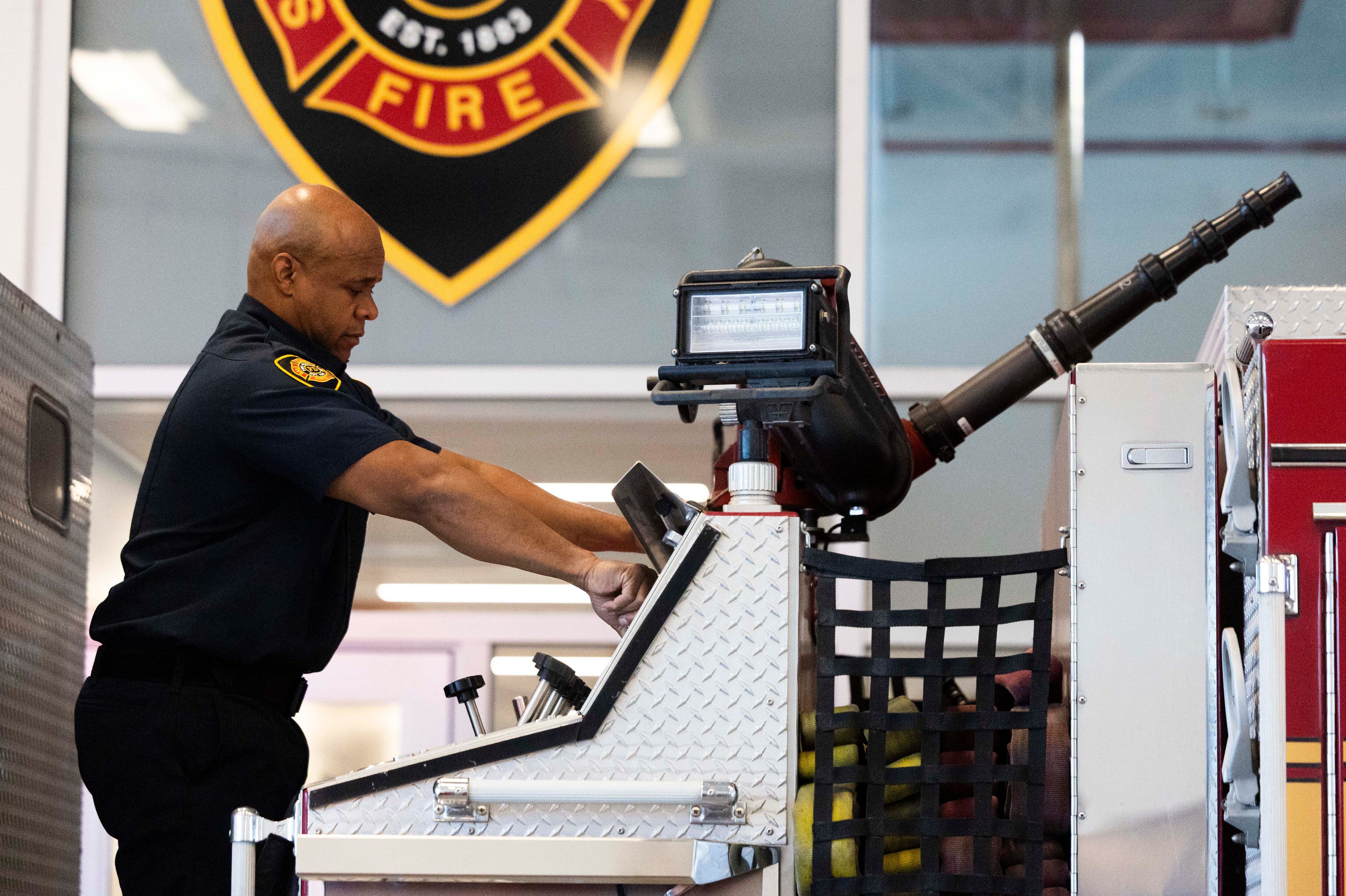 Salt Lake City firefighter Gary Perkins checks the fire hose on a fire engine while running through and checking their equipment at Salt Lake City Fire Station 3 in Salt Lake City on Tuesday.