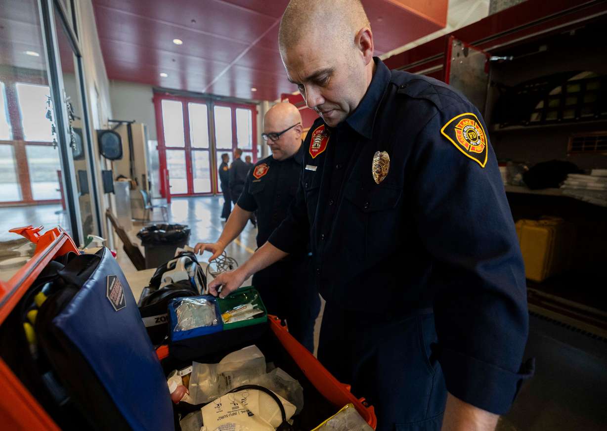Salt Lake City firefighter Justus Seeley, right, conducts an equipment check with fellow firefighter Justin LaMarr, left, at Salt Lake City Fire Station 3 in Salt Lake City on Tuesday.