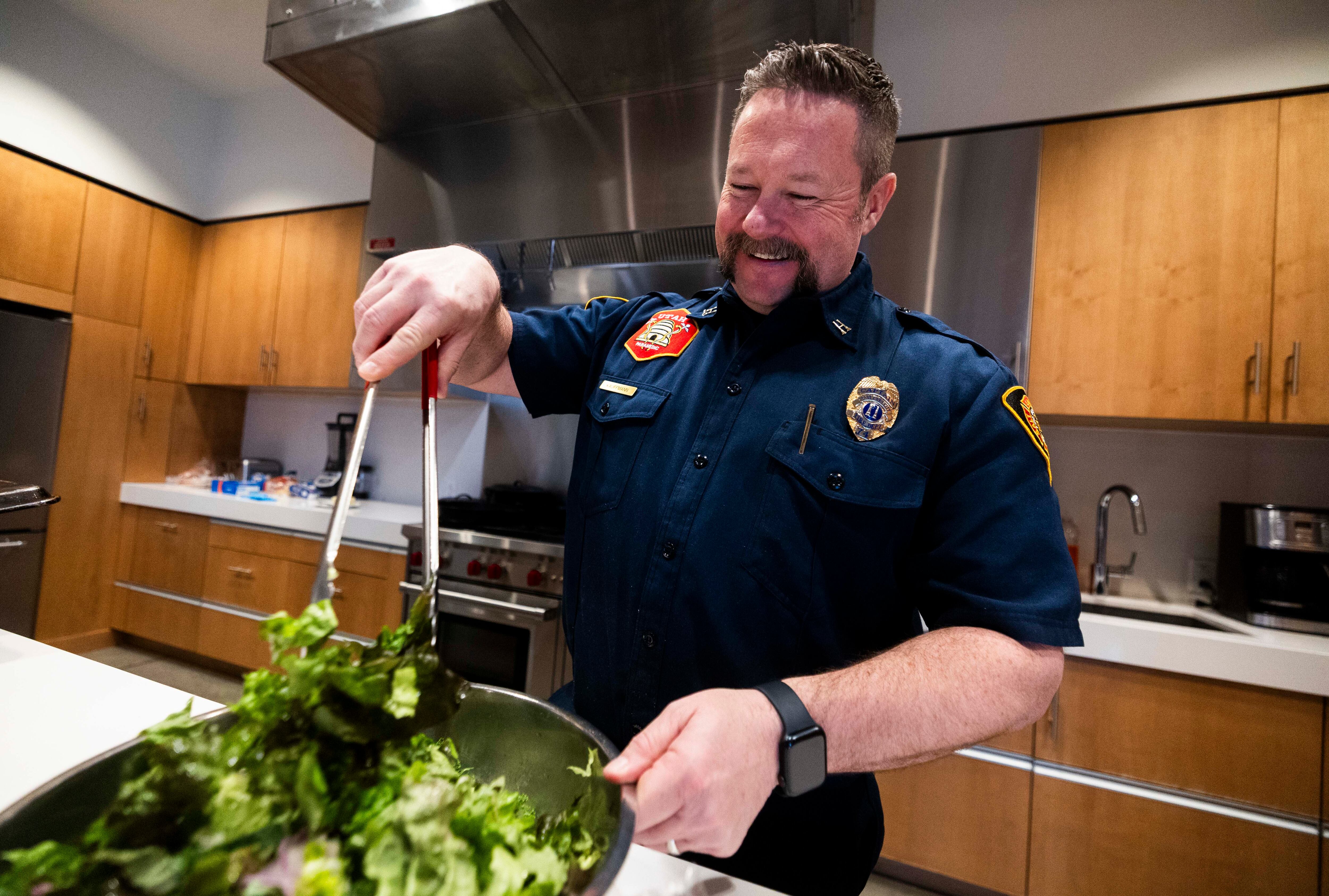 Salt Lake City Fire Capt. Jeff Kauffmann prepares a salad at Salt Lake City Fire Station 3 in Salt Lake City on Tuesday.