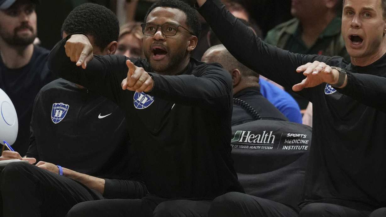 Duke associate coach Jai Lucas and head coach Jon Scheyer gesture during the second half of an NCAA college basketball game against Miami , Tuesday, Feb. 25, 2025, in Coral Gables, Fla.