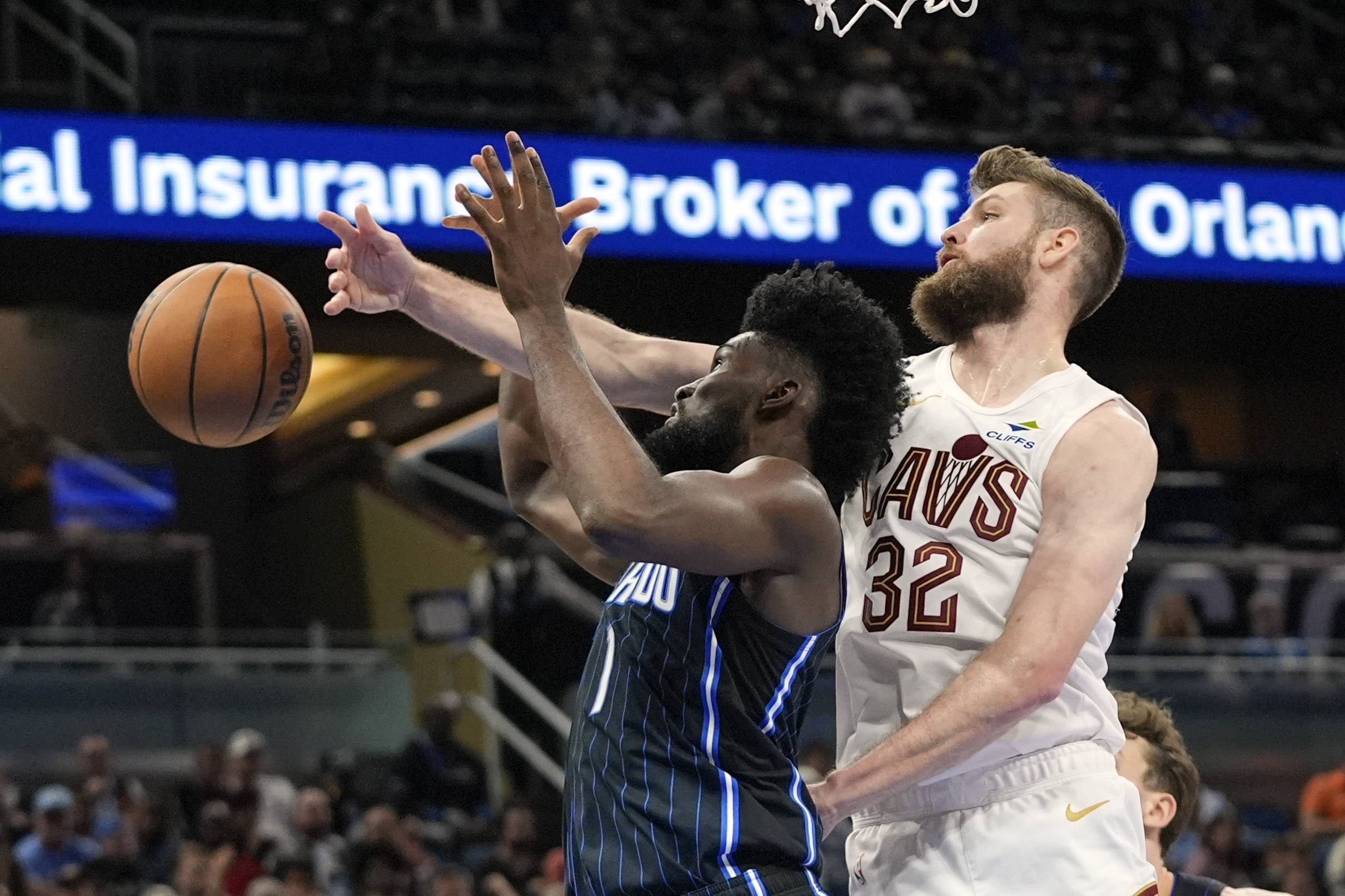 Orlando Magic forward Jonathan Isaac, left, and Cleveland Cavaliers forward Dean Wade (32) go after a rebound during the second half of an NBA basketball game, Tuesday, Feb. 25, 2025, in Orlando, Fla. 