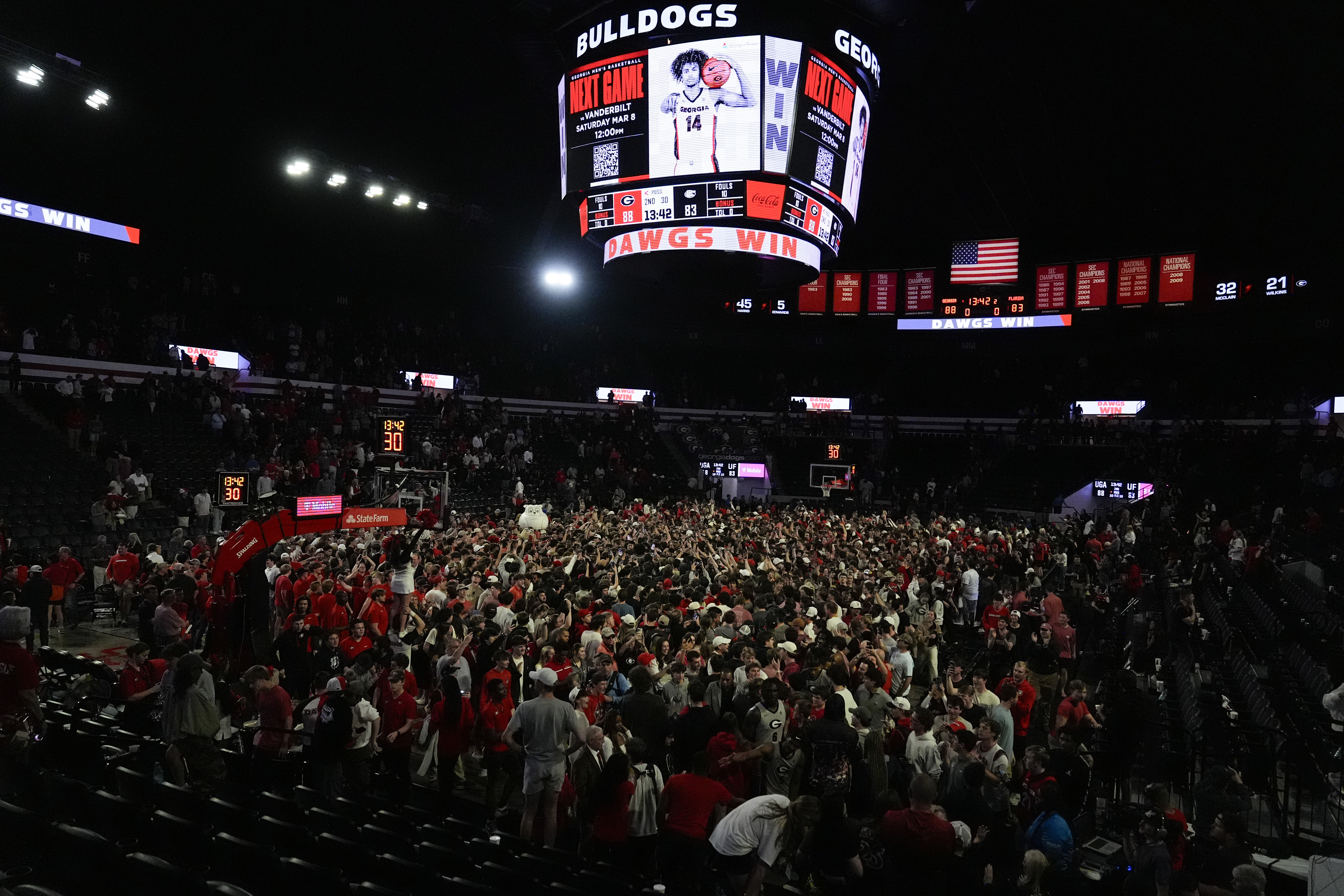 Georgia fans rush the court in celebration after an NCAA college basketball game against Florida, Tuesday, Feb. 25, 2025, in Athens, Ga.