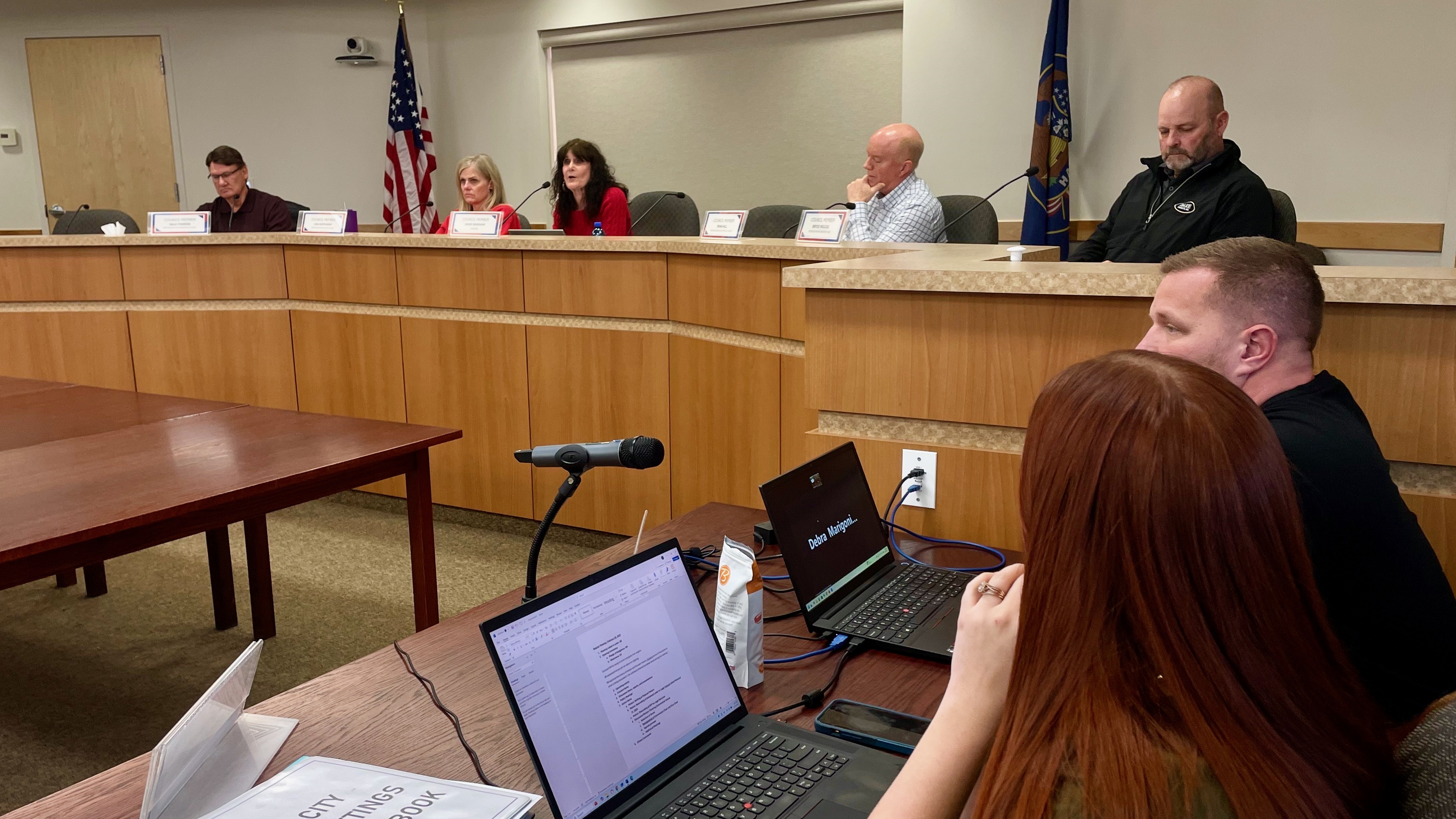 A measure to strip the Hooper mayor of power, spurred in part by apparent differences between the mayor and her brother, a councilman, has been tabled after a crowded council meeting Tuesday. Mayor Sheri Bingham is pictured in the middle, in red.