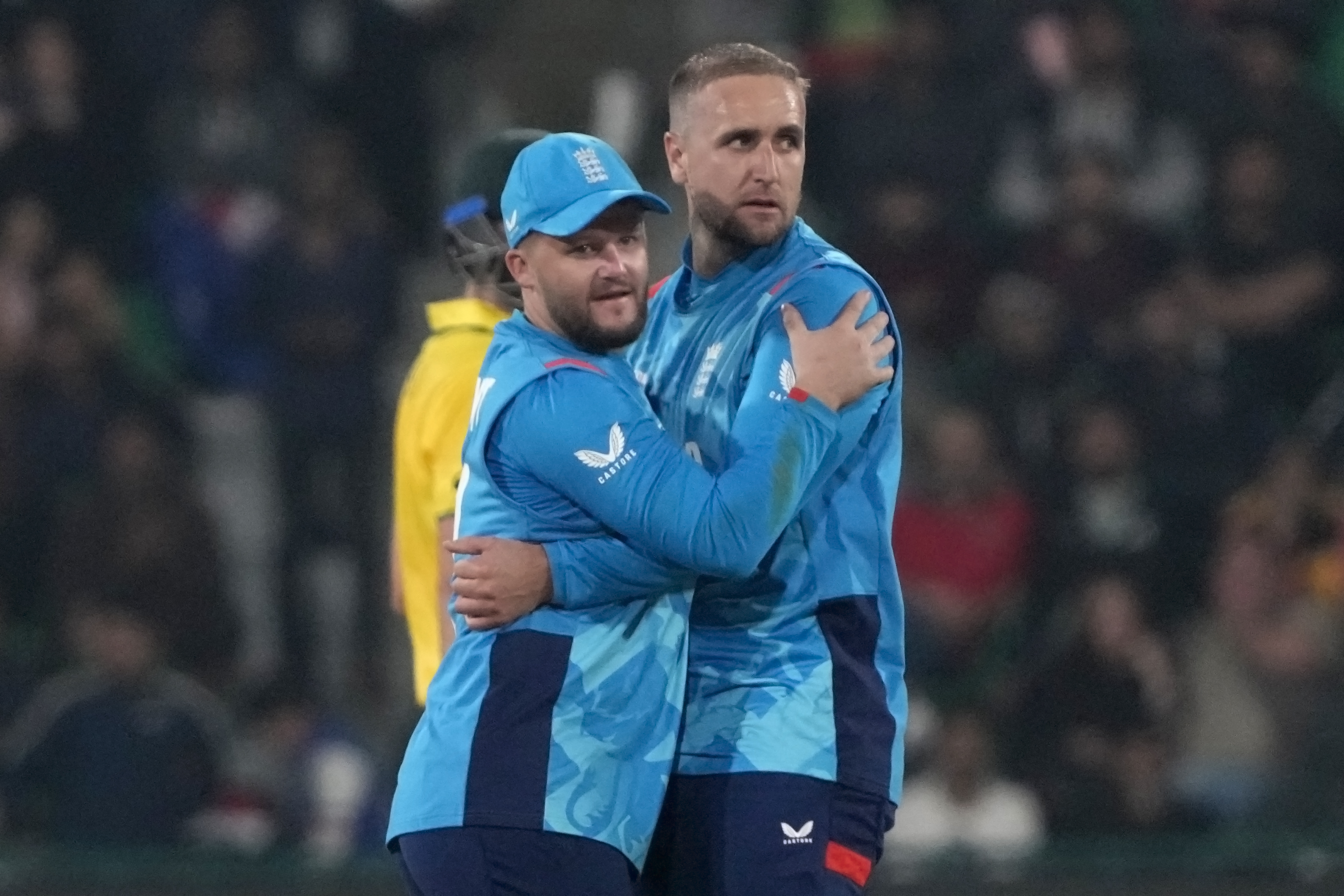 England's Liam Livingstone, right, celebrates with teammate after the dismissal of Australia's Matthew Short during the ICC Champions Trophy cricket match between Australia and England, in Lahore, Pakistan, Saturday, Feb. 22, 2025. 