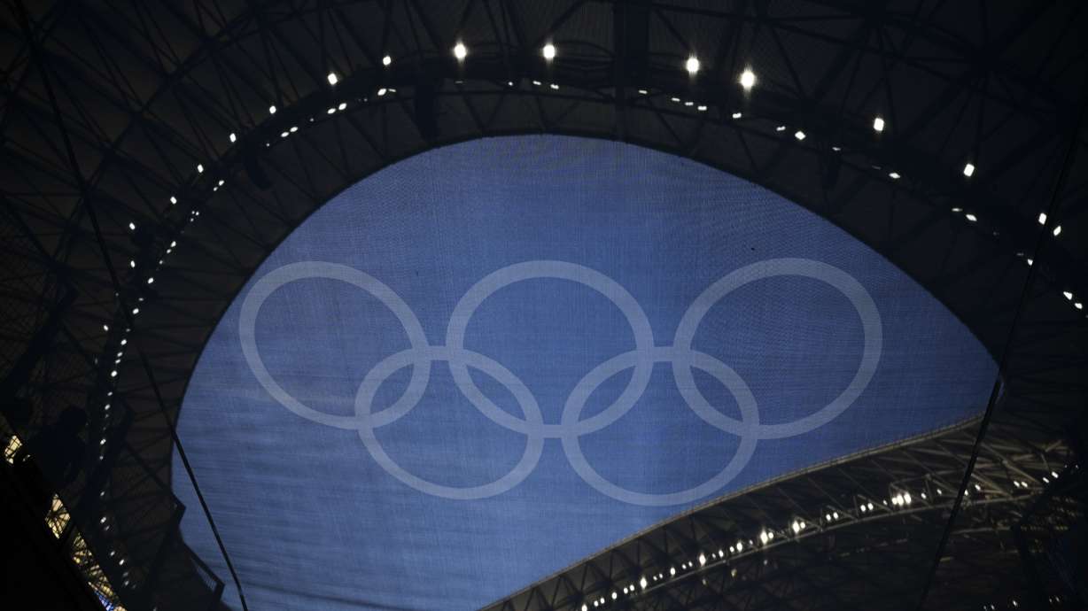 FILE - The Olympic rings are pictured through a flag hanging in the Velodrome stadium during the Summer Olympics, July 24, 2024, in Marseille, France.