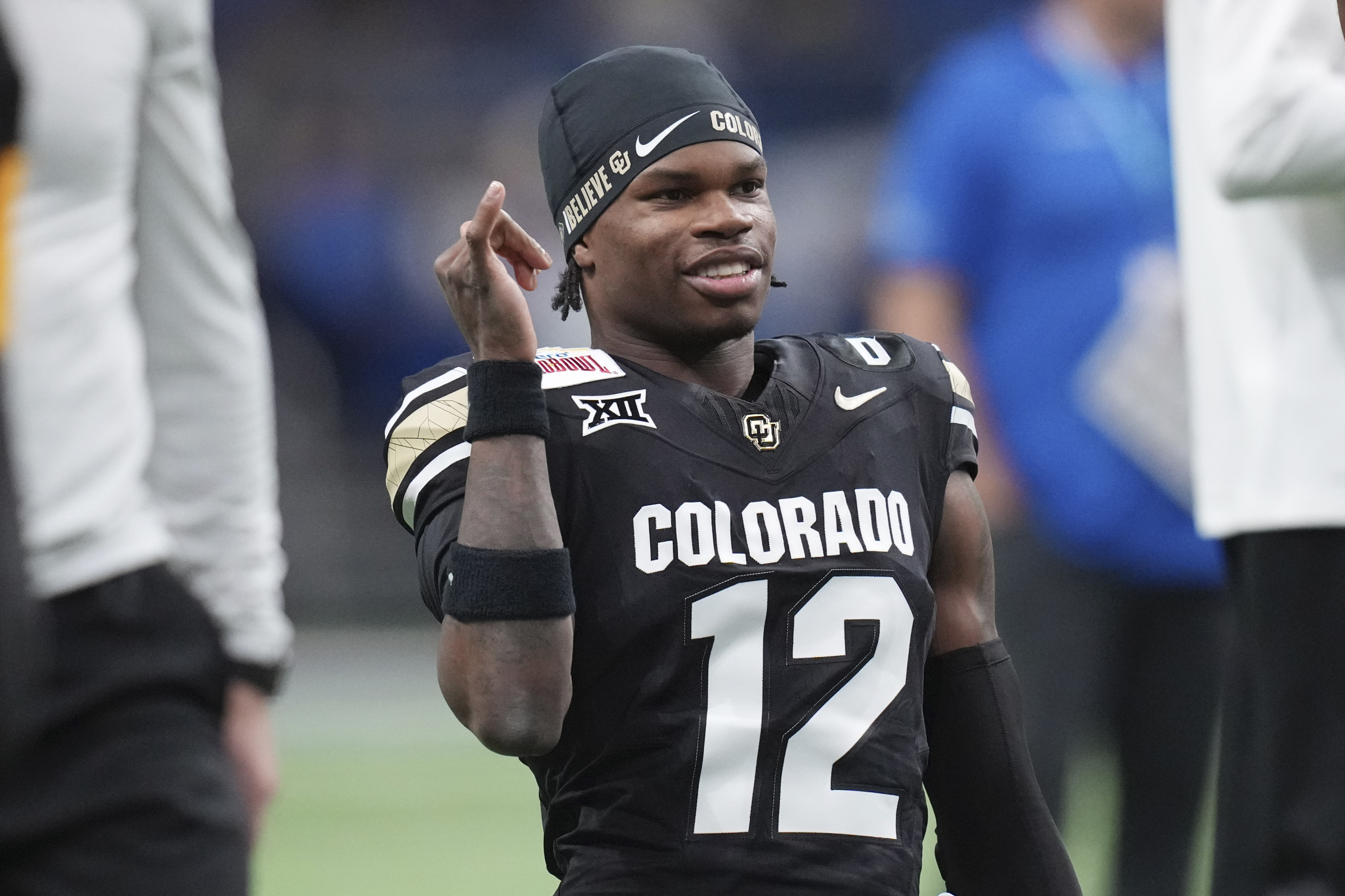 FILE - Colorado wide receiver Travis Hunter (12) warms up for the Alamo Bowl NCAA college football game against BYU, Dec. 28, 2024, in San Antonio. 