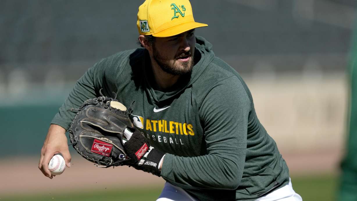 Athletics' Shea Langeliers throws during a spring training baseball workout, Friday, Feb. 21, 2025, in Mesa, Ariz.