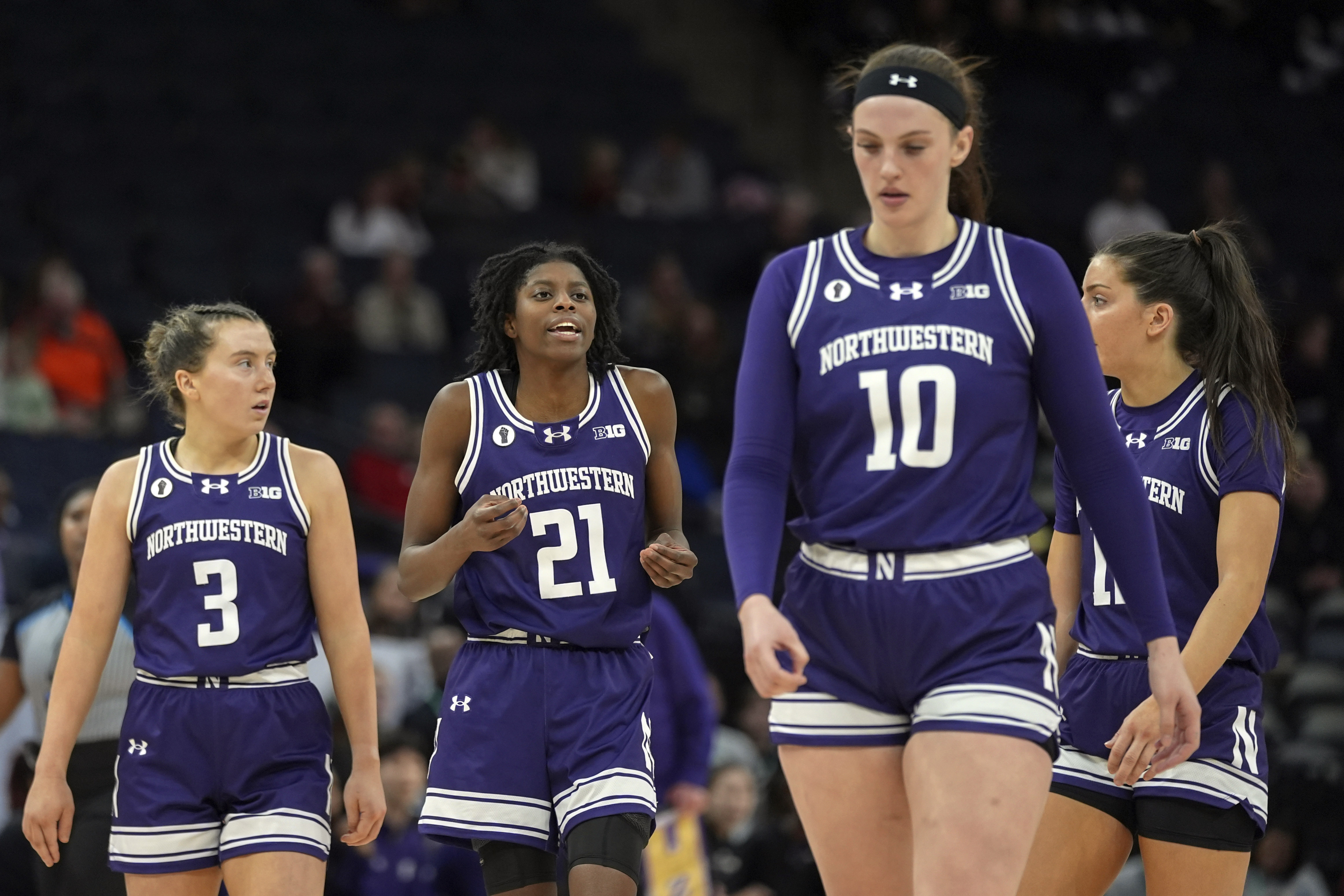 FILE - Northwestern guards Maggie Pina (3), Melannie Daley (21), forward Caileigh Walsh (10) and guard Casey Harter walk down the court during the second half of an NCAA college basketball game against Purdue at the Big Ten women's tournament, March 6, 2024, in Minneapolis. 