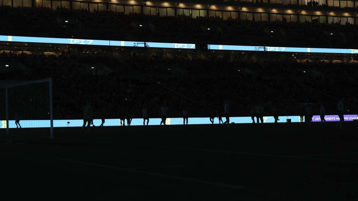 Players stand around during a short power cut during the Women's Nations League soccer match between England and Spain at Wembley Stadium in London, England, Wednesday Feb. 26, 2025.