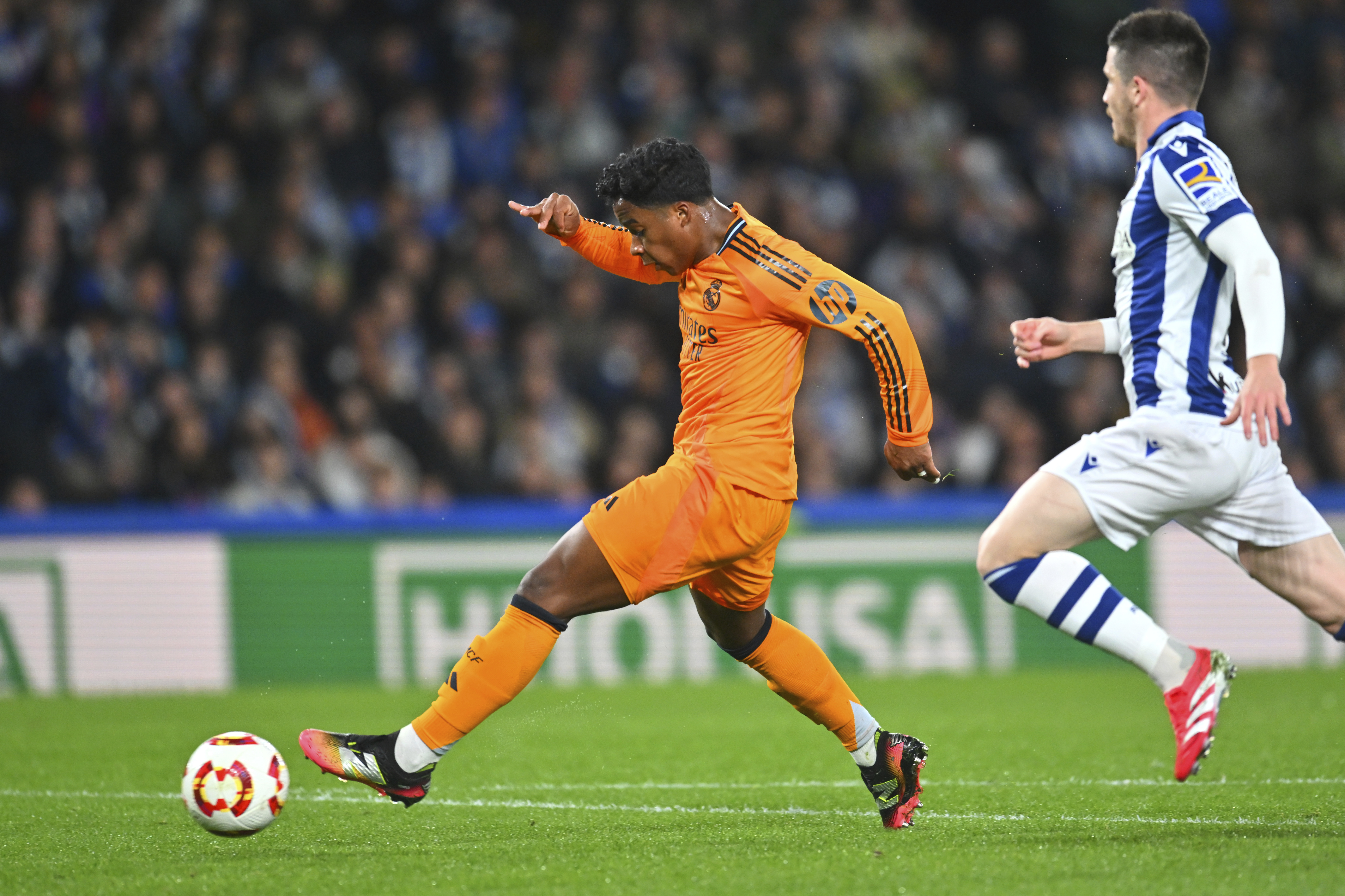 Real Madrid's Endrick, left, scores his side's opening goal during the Spanish Copa del Rey soccer match between Real Sociedad and Real Madrid at the Reale Arena in San Sebastian, Spain, Wednesday, Feb. 26, 2025. 