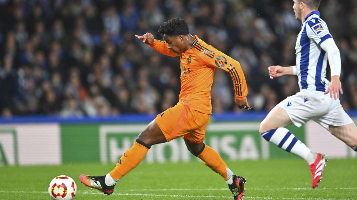 Real Madrid's Endrick, left, scores his side's opening goal during the Spanish Copa del Rey soccer match between Real Sociedad and Real Madrid at the Reale Arena in San Sebastian, Spain, Wednesday, Feb. 26, 2025.