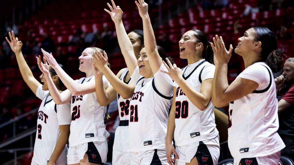 West players celebrate a teammate’s 3-pointer from the bench during the 5A girls basketball semifinals against Salem Hills held at the Huntsman Center in Salt Lake City on Wednesday, Feb. 26, 2025.