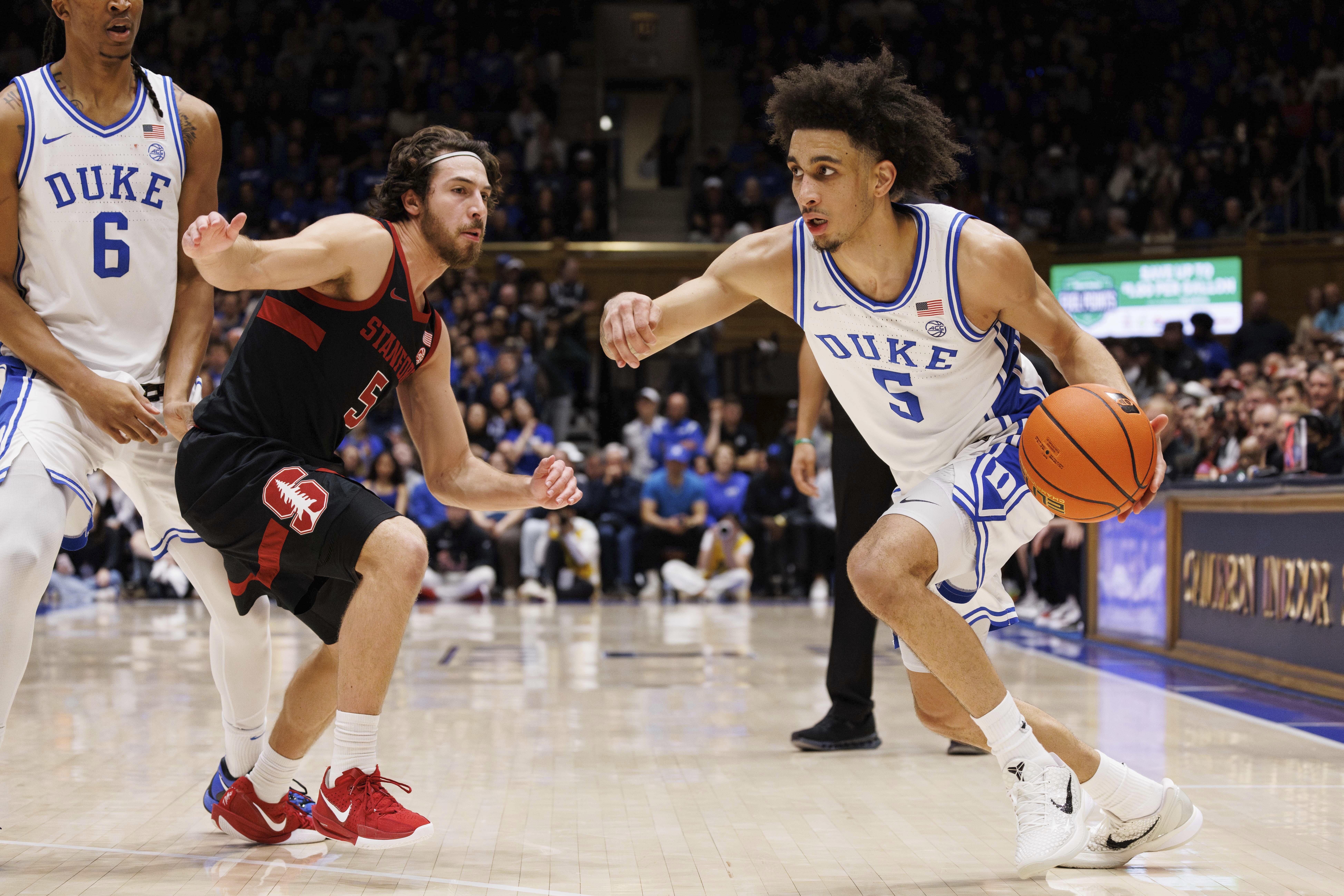 Duke's Tyrese Proctor, right, handles the ball as Stanford's Benny Gealer, left, defends during the second half of an NCAA college basketball game in Durham, N.C., Saturday, Feb. 15, 2025. 