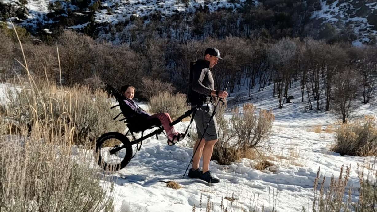 LJ Wilde and Luci using the Cascade Cart to enjoy the outdoors together.