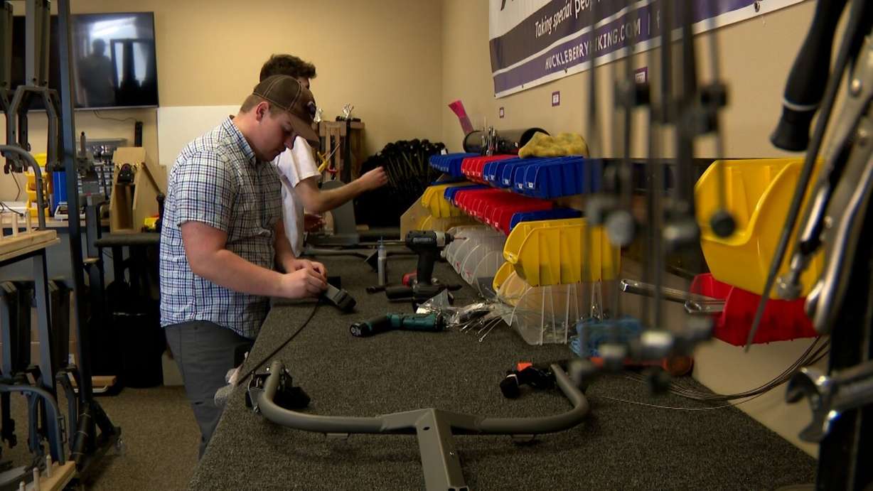 Workers at Huckleberry Hiking building Cascade Carts at the workshop.