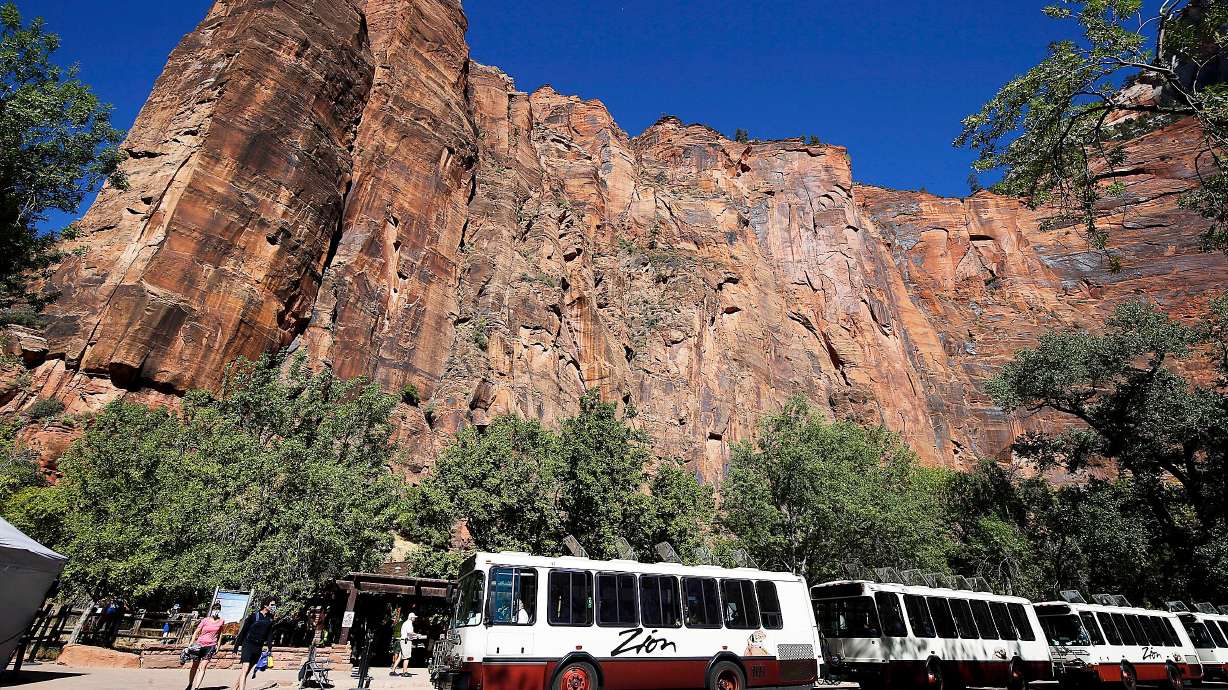 Visitors board shuttles at Zion National Park on Wednesday, Oct. 14, 2020. More than 10,000 federal workers across multiple agencies, including the National Park Service, have lost jobs as part of “large-scale reductions” in the government workforce.