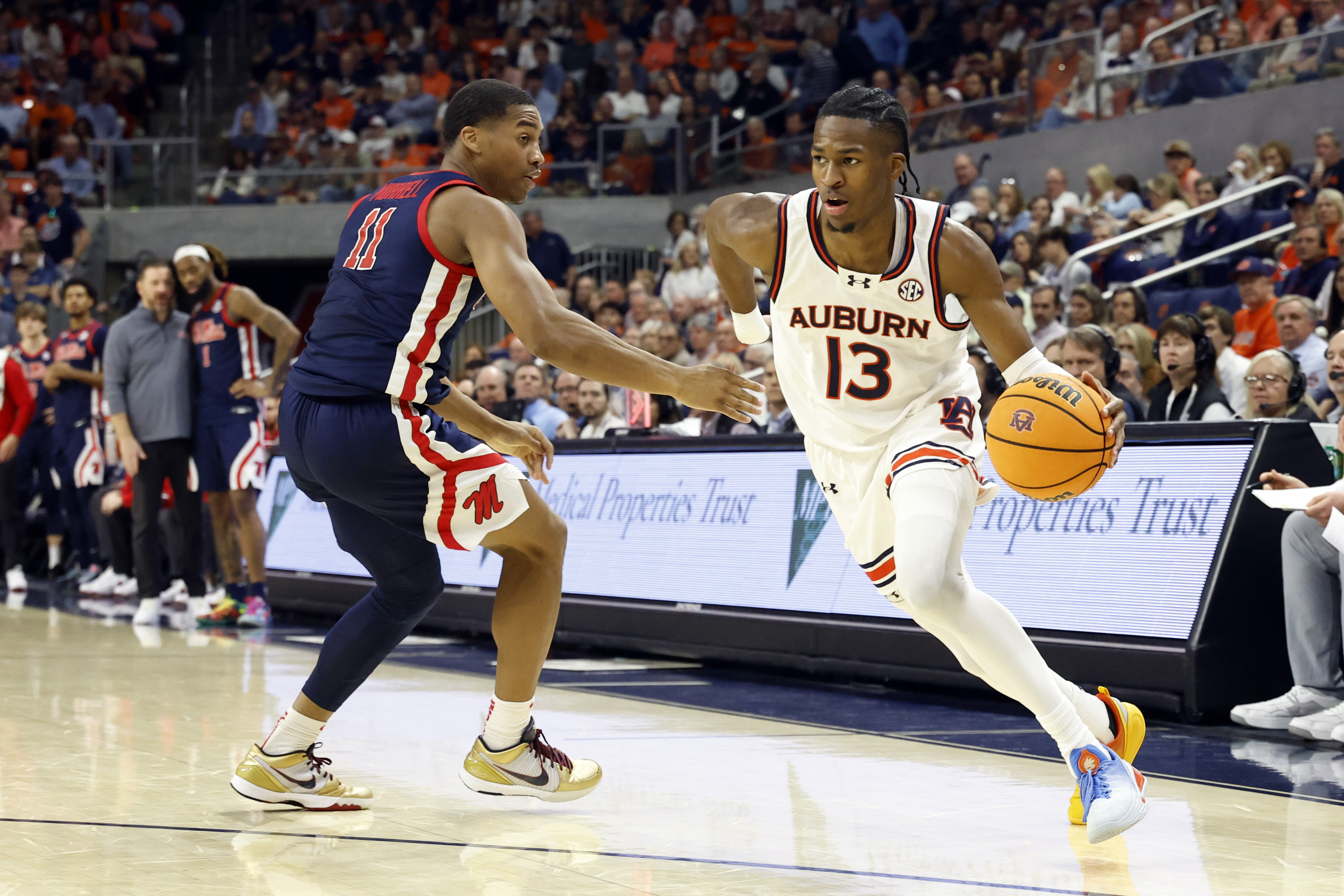 Auburn guard Miles Kelly (13) drives the baseline around Mississippi guard Matthew Murrell (11) during the second half of an NCAA college basketball game, Wednesday, Feb. 26, 2025, in Auburn, Ala.
