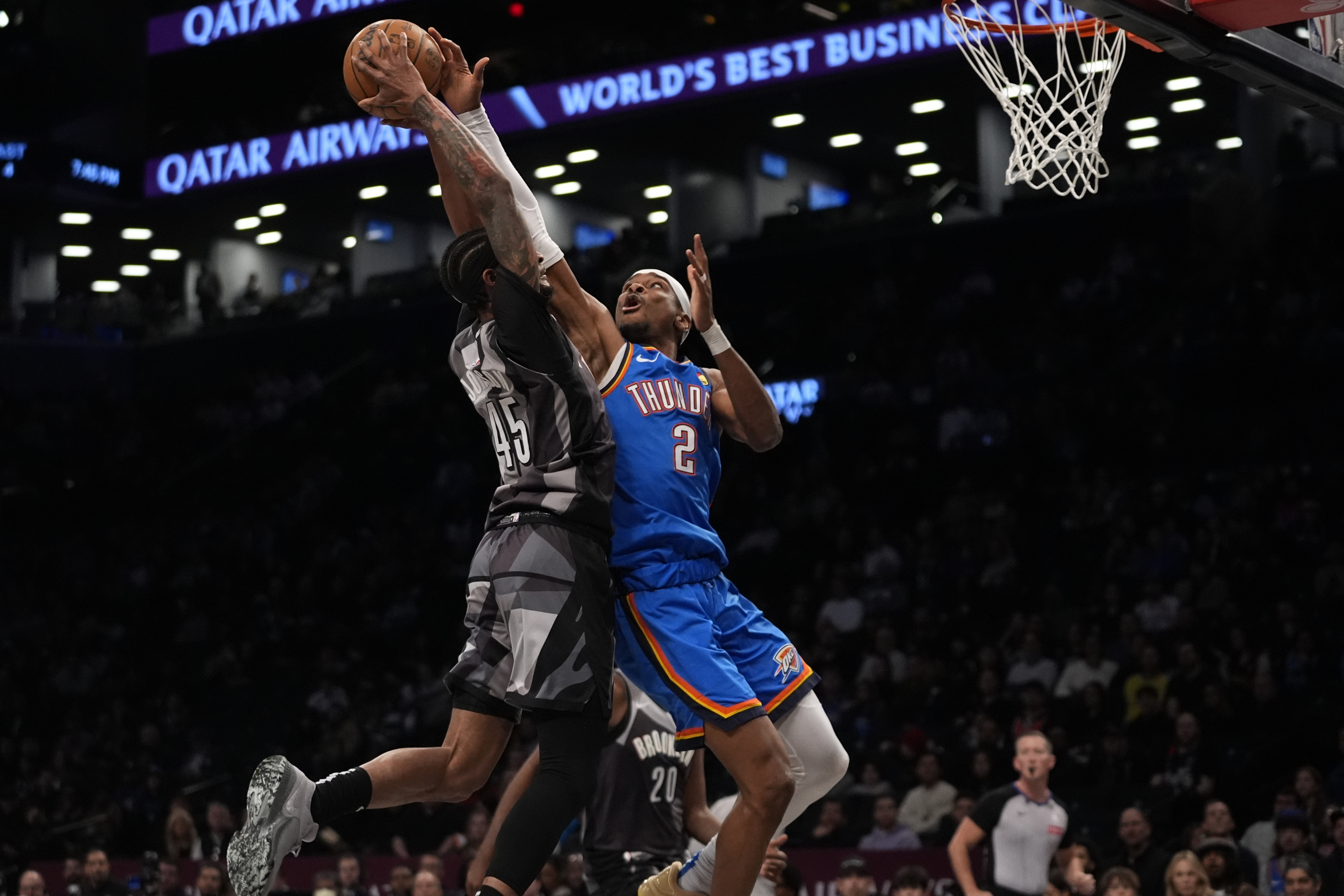 Oklahoma City Thunder's Shai Gilgeous-Alexander (2) defends a shot by Brooklyn Nets' Keon Johnson (45) during the first half of an NBA basketball game Wednesday, Feb. 26, 2025, in New York.