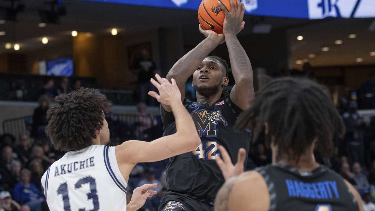 Memphis forward Dain Dainja (42) shoots defended by Rice forward Andrew Akuchie (13) during the first half of an NCAA college basketball game, Wednesday, Feb. 26, 2025, in Memphis, Tenn.