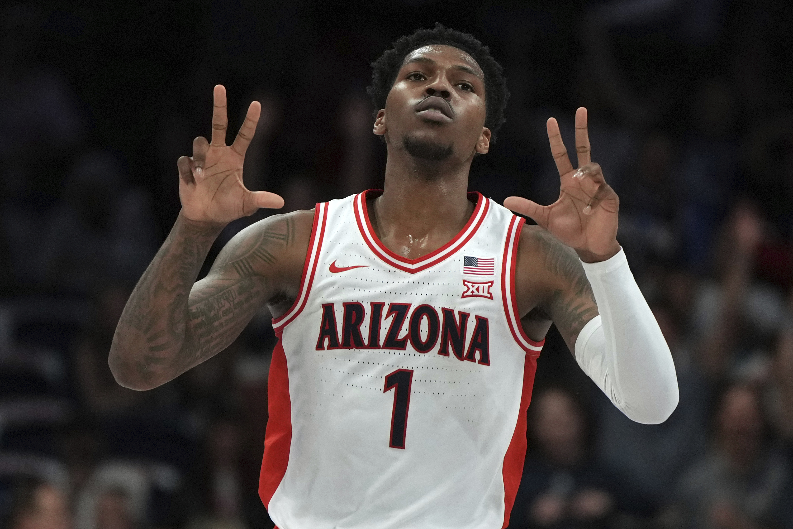 Arizona guard Caleb Love reacts after scoring against Utah during the first half of an NCAA college basketball game, Wednesday, Feb. 26, 2025, in Tucson, Ariz. 