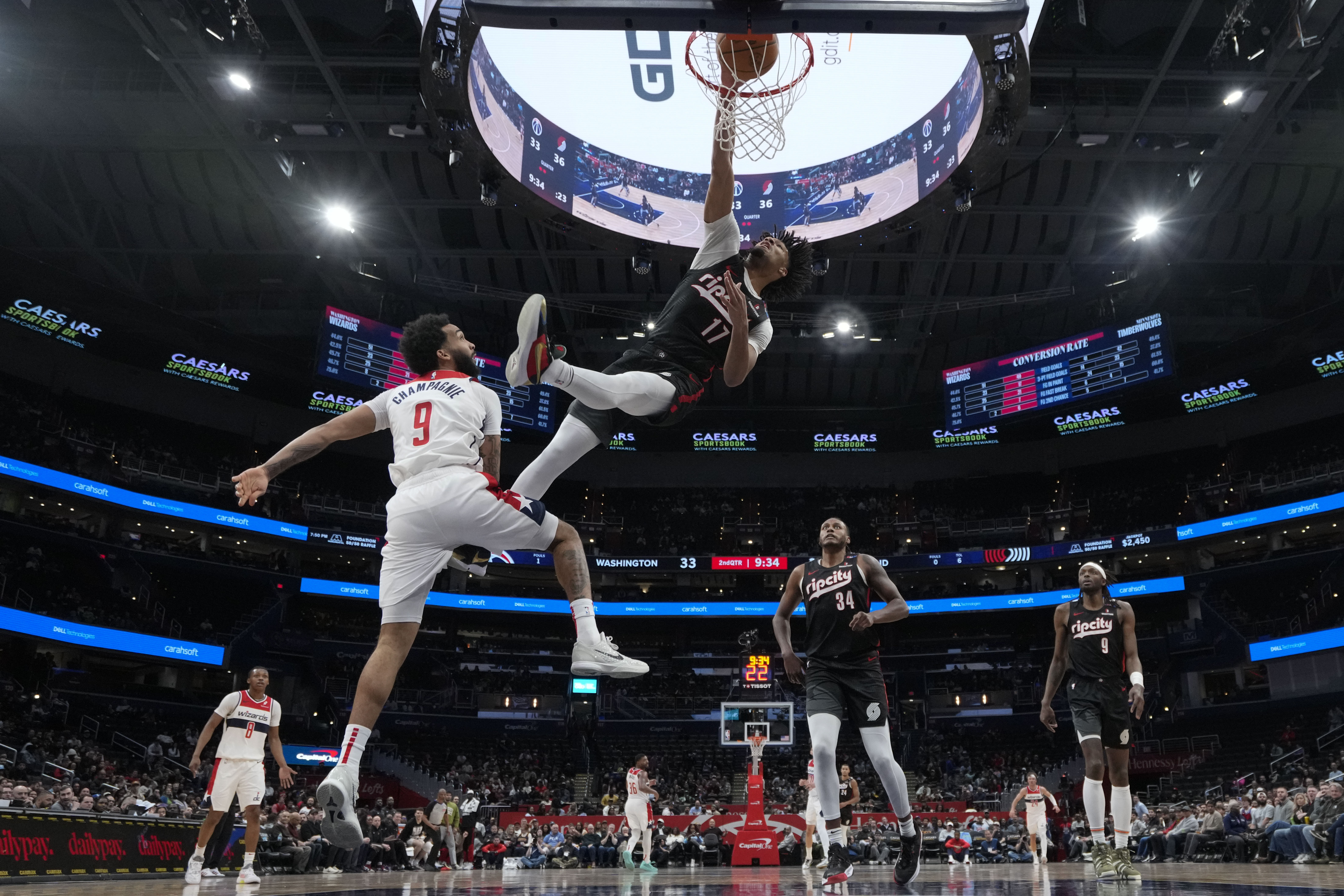 Portland Trail Blazers guard Shaedon Sharpe (17) dunks against Washington Wizards forward Justin Champagnie (9) during the first half of an NBA basketball game, Wednesday, Feb. 26, 2025, in Washington. 