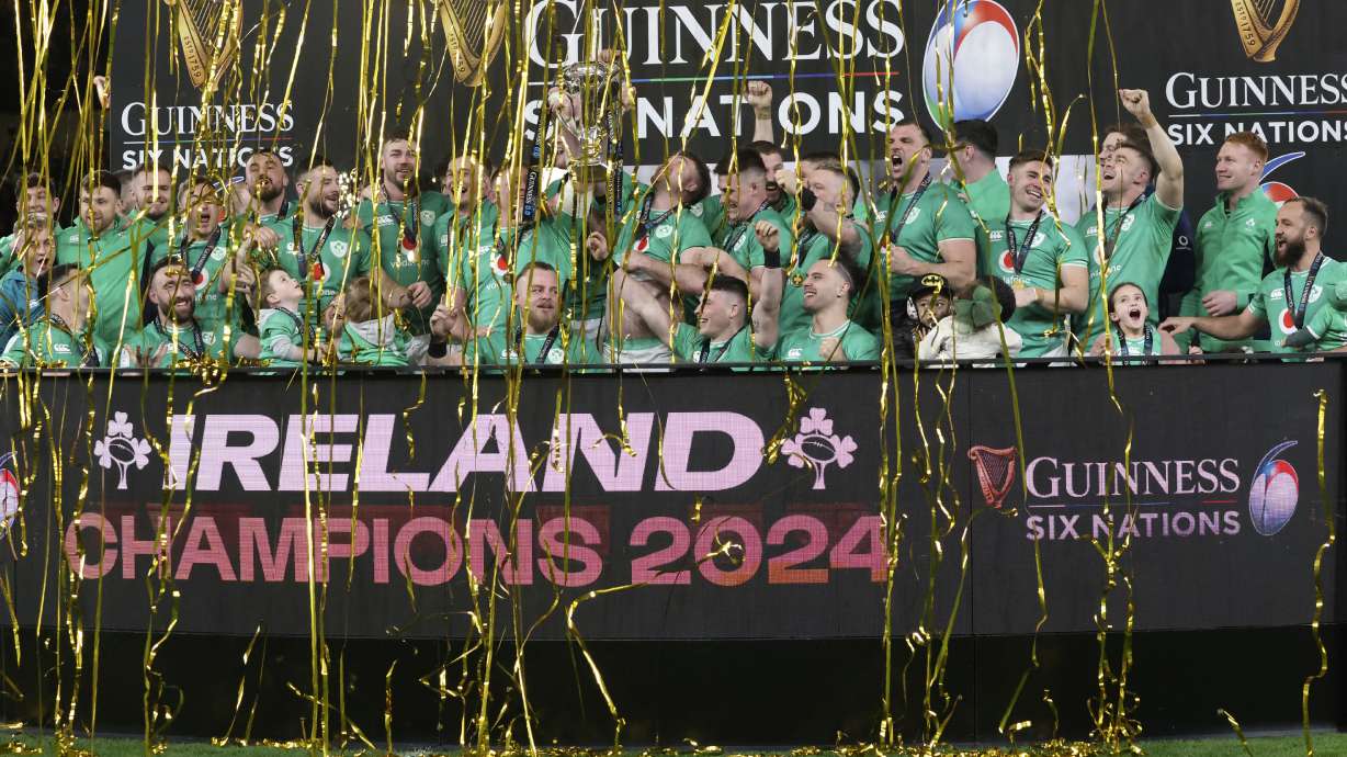 FILE - Ireland's Peter O'Mahony, centre right, and Tadgh Furlong, centre left, lift the Six Nations trophy after defeating Scotland in their rugby union international match at the Aviva stadium in Dublin, Ireland, March 16, 2024.