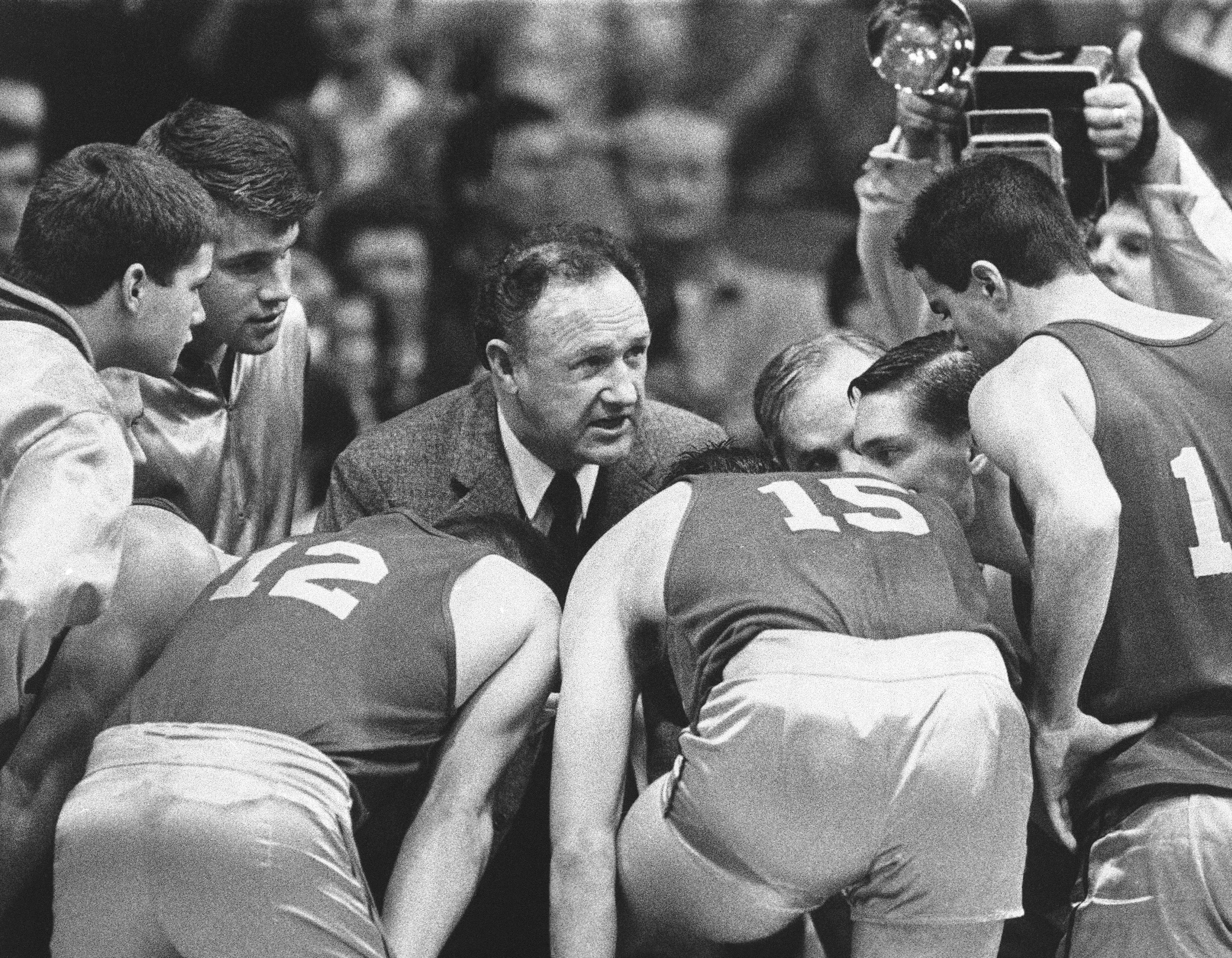FILE - Actor Gene Hackman gives fictional Hickory High basketball players instructions during filming of the final game of the movie "Hoosiers" at Hinkle Fieldhouse on the Butler University campus, Friday, Dec. 6, 1985 in Indianapolis. 
