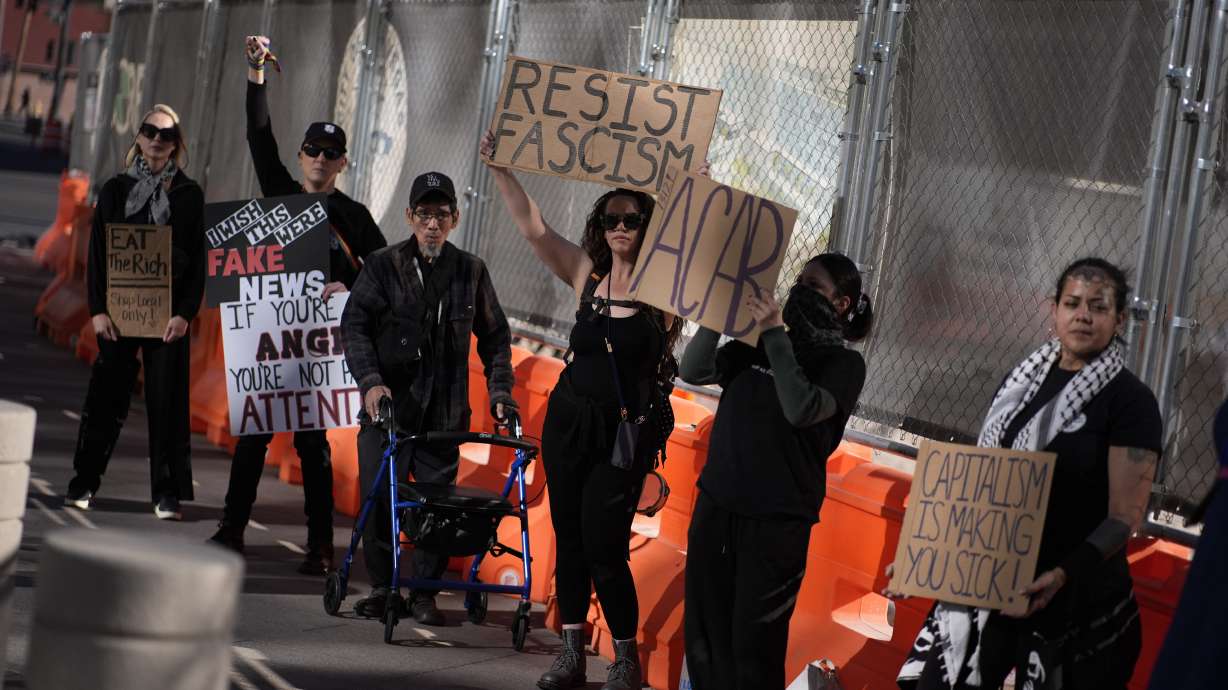Protesters hold signs during a rally for a nationwide economic blackout Wednesday, in Las Vegas. A grassroots organization is encouraging U.S. residents not to spend any money on Friday.