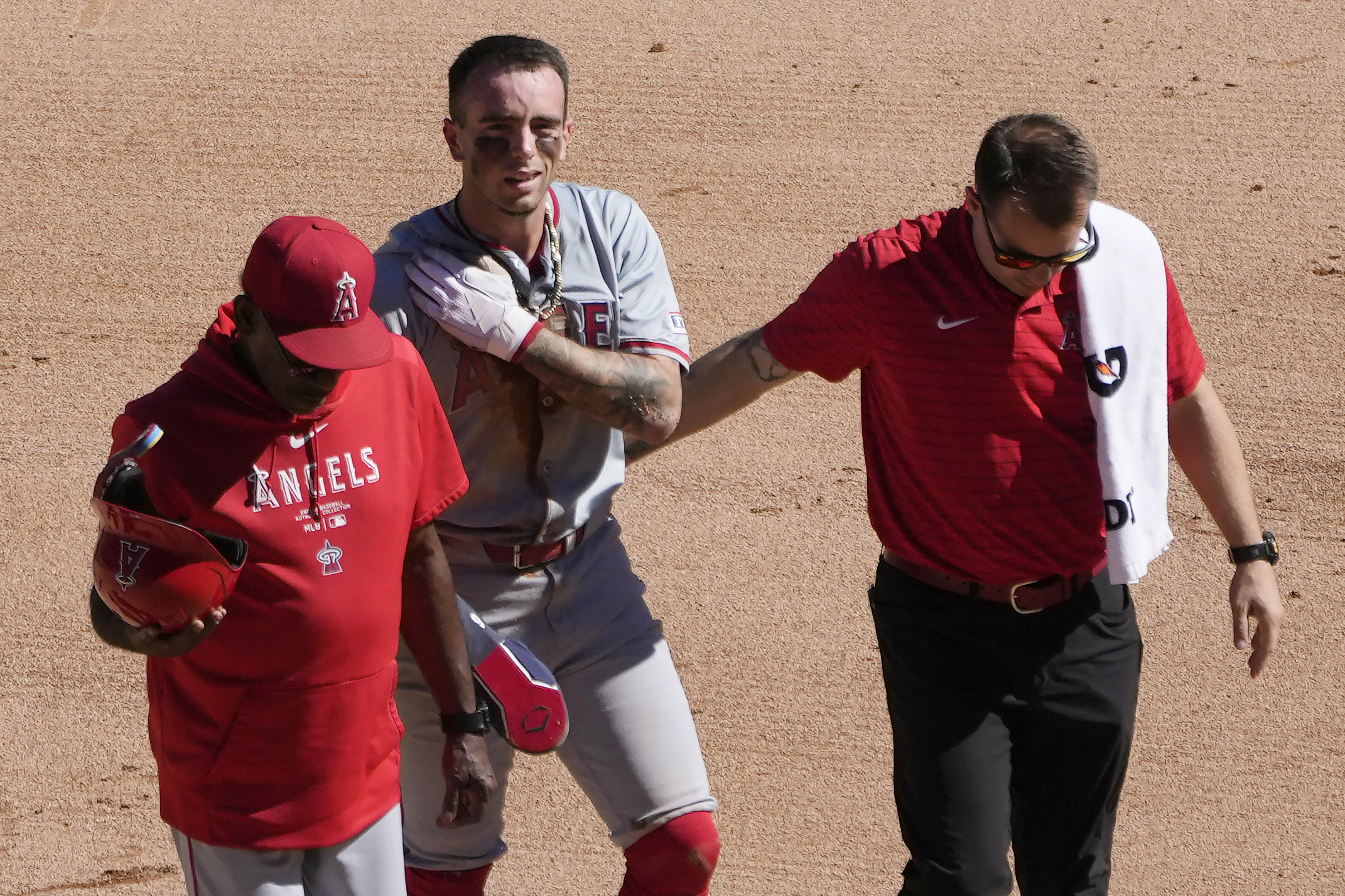 FILE - Los Angeles Angels' Zach Neto holds his shoulder as he heads to the dugout after being caught trying to steal second during the fourth inning of a baseball game against the Chicago White Sox on Thursday, Sept. 26, 2024, in Chicago. 