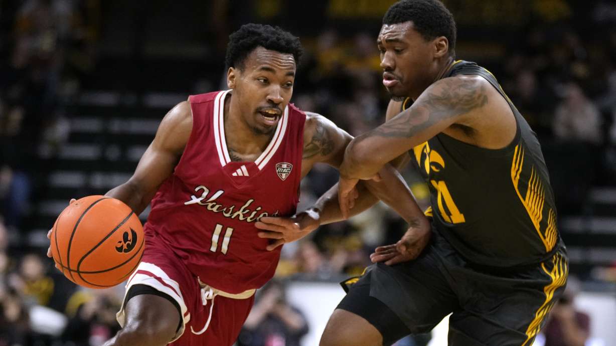 FILE- Northern Illinois guard David Coit (11) drives past Iowa guard Tony Perkins (11) during the first half of an NCAA college basketball game, Friday, Dec. 29, 2023, in Iowa City, Iowa.