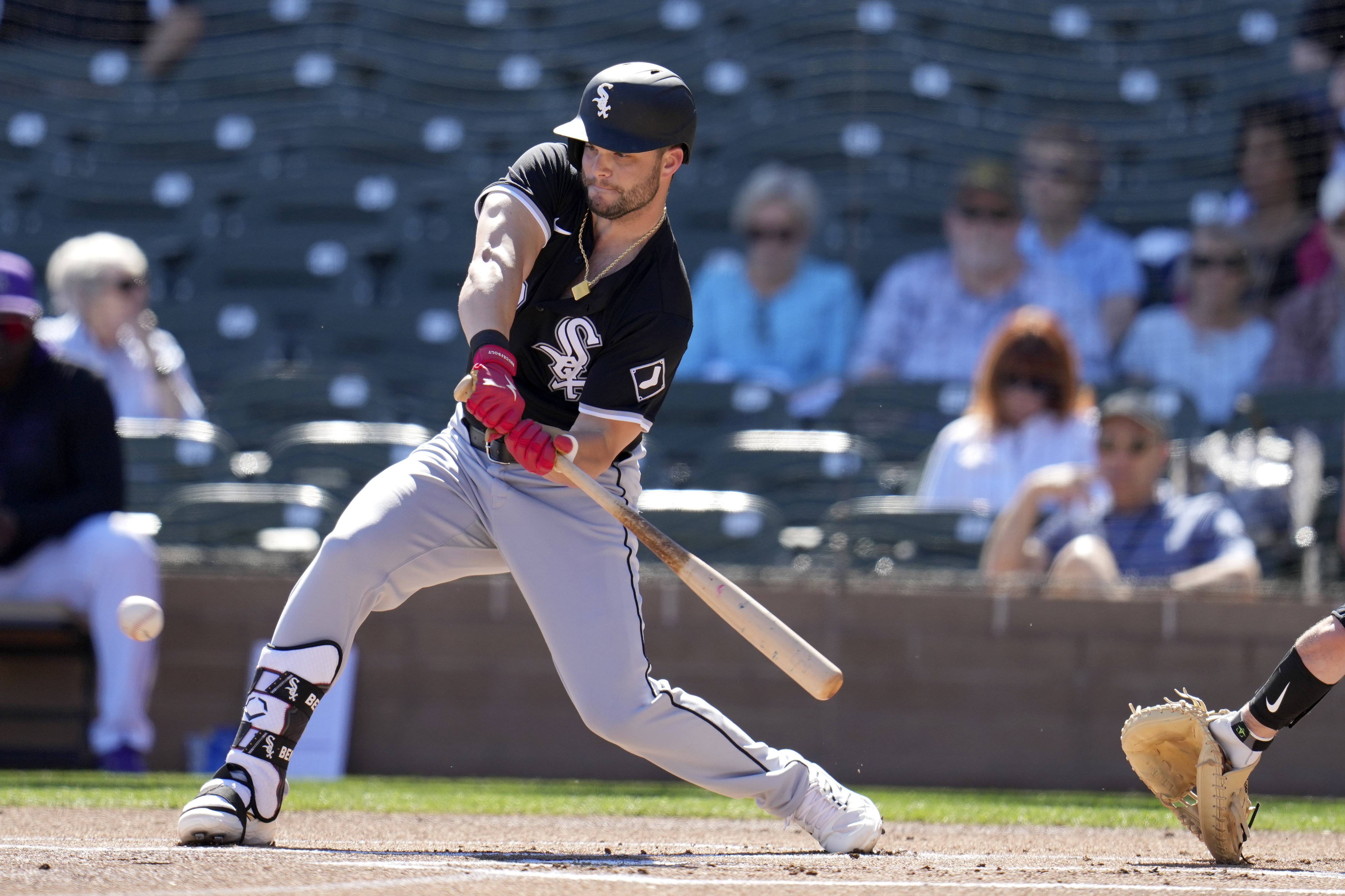 FILE - Chicago White Sox's Andrew Benintendi checks his swing during the first inning of a spring training baseball game against the Colorado Rockies, Tuesday, Feb. 25, 2025, in Scottsdale, Ariz. 