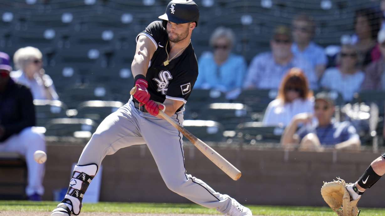 FILE - Chicago White Sox's Andrew Benintendi checks his swing during the first inning of a spring training baseball game against the Colorado Rockies, Tuesday, Feb. 25, 2025, in Scottsdale, Ariz.