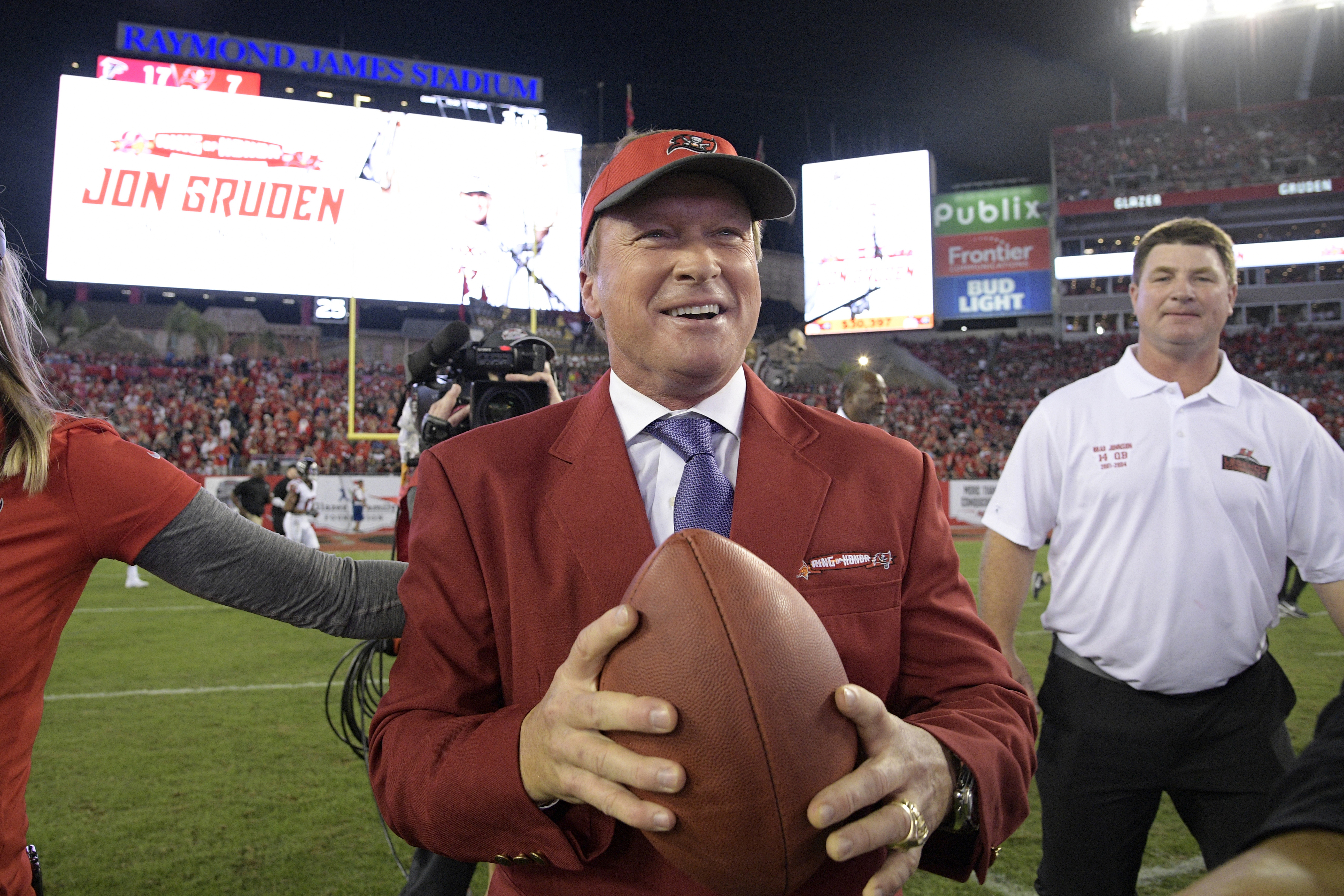 FILE - Former Tampa Bay Buccaneers head coach Jon Gruden, center, reacts after being inducted into the Buccaneers Ring of Honor during halftime of an NFL football game against the Atlanta Falcons Monday, Dec. 18, 2017, in Tampa, Fla. 